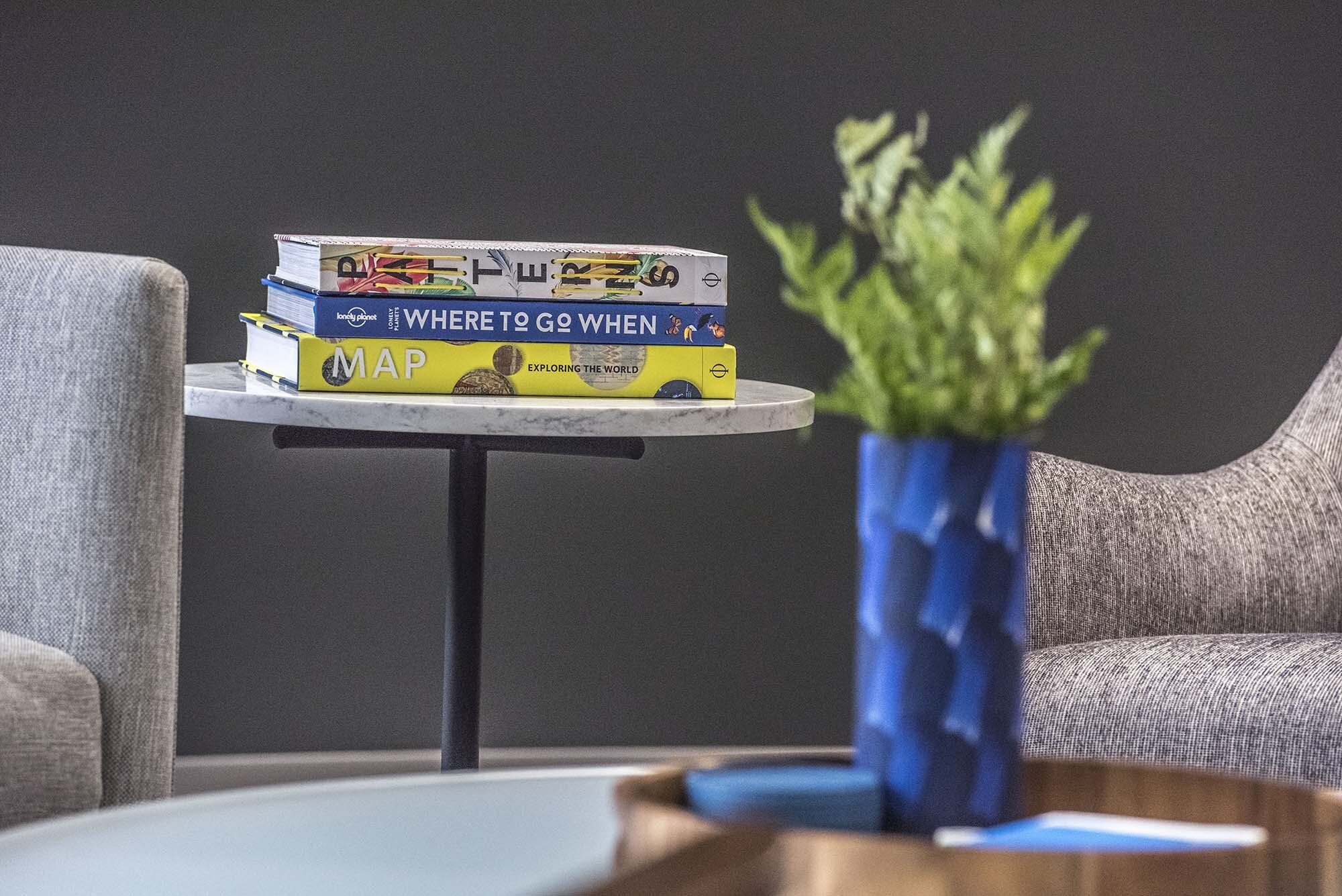 Columbia Plaza Closeup of Book stack on table with plant