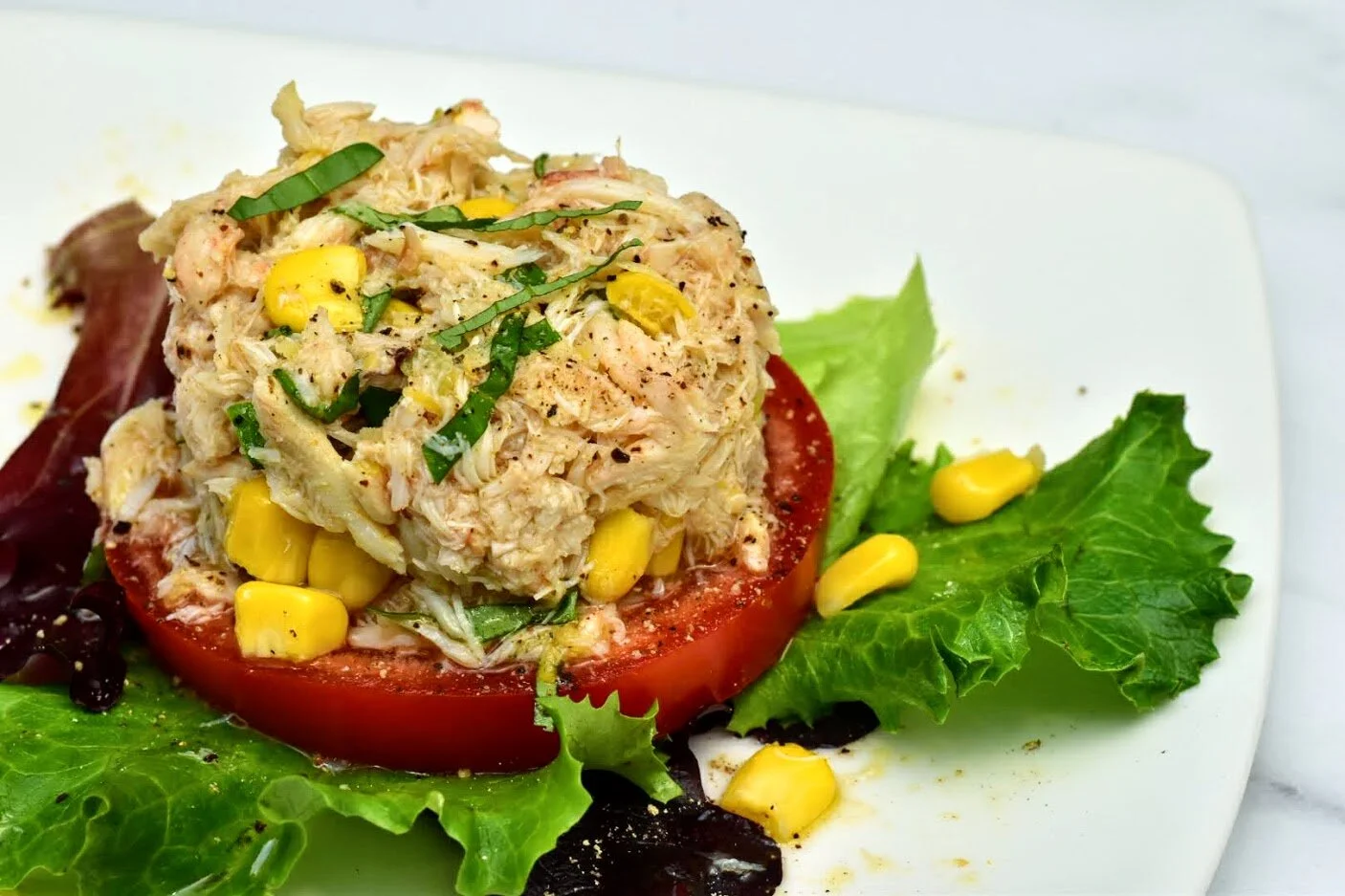 Photo c. foodblogchef 2020  Copy and paste to print the recipe.  CRAB AND CORN SALAD WITH TOMATO Serves 4  Ingredients: 4 large tomato slices, about ½ inch thick a scant 1/4 cup extra virgin olive oil ½ cup corn kernels (fresh off the cob are sweete…