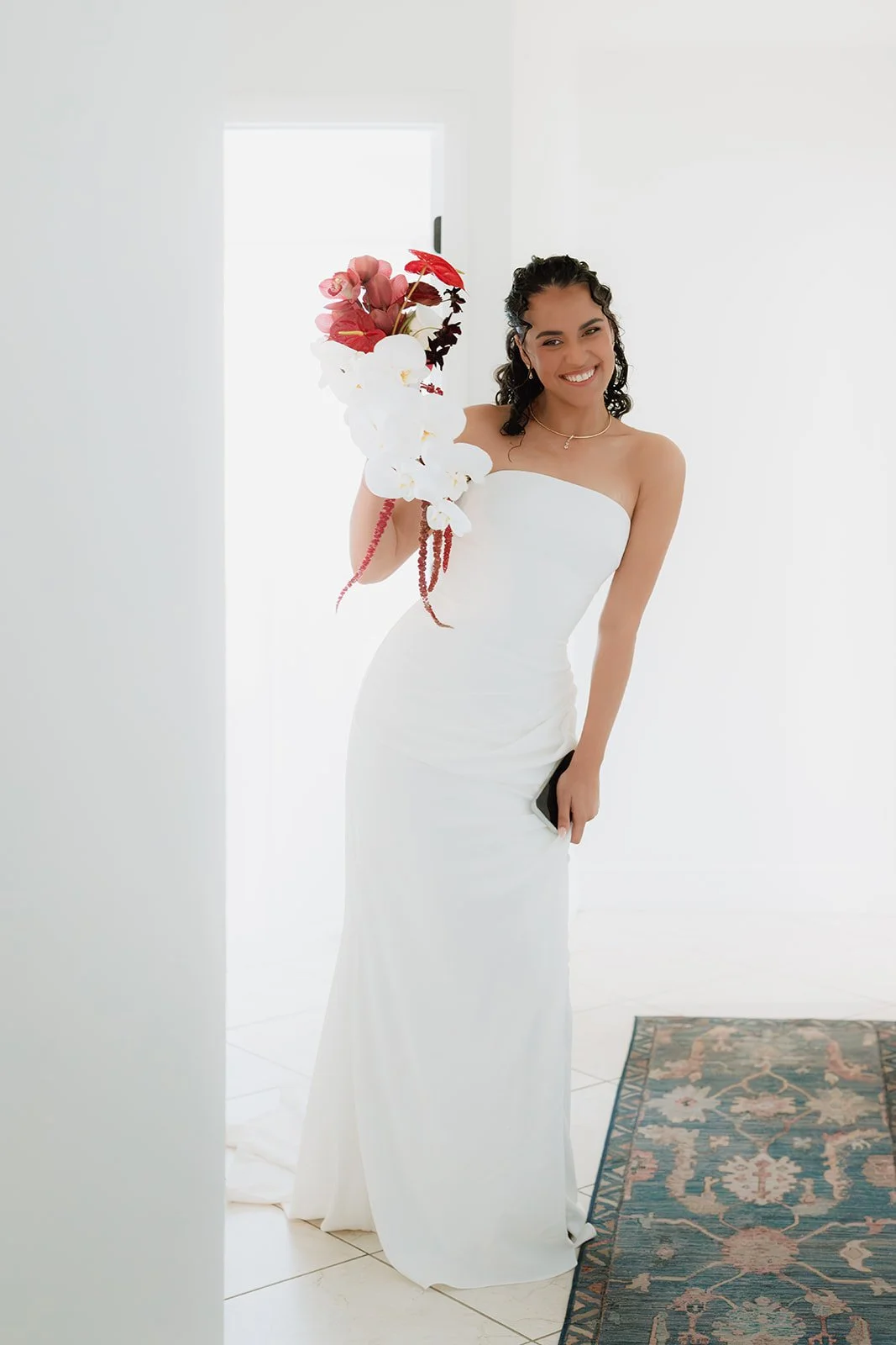 Bride holding a white orchid cascading bouquet during a luxury South Florida wedding.