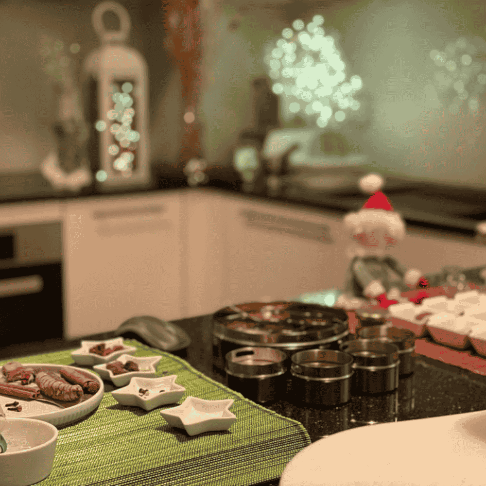 Indian spice tins in a festive kitchen, ready for a virtual spice workshop for remote teams