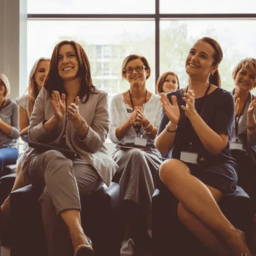 A team clapping in a meeting
