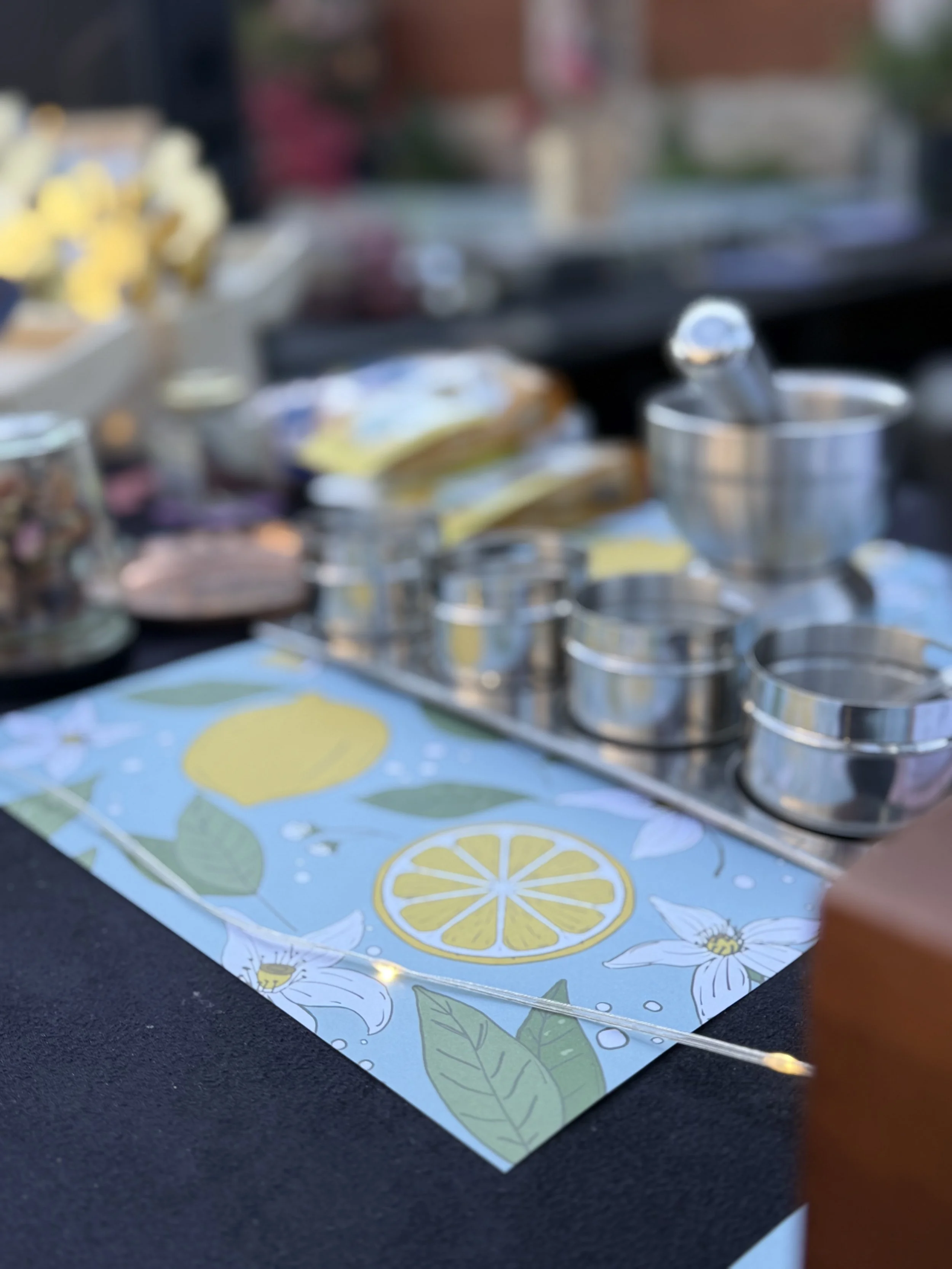 Steel spice bowls set up on a lemon tablecloth for an Indian cooking team building workshop in Berlin