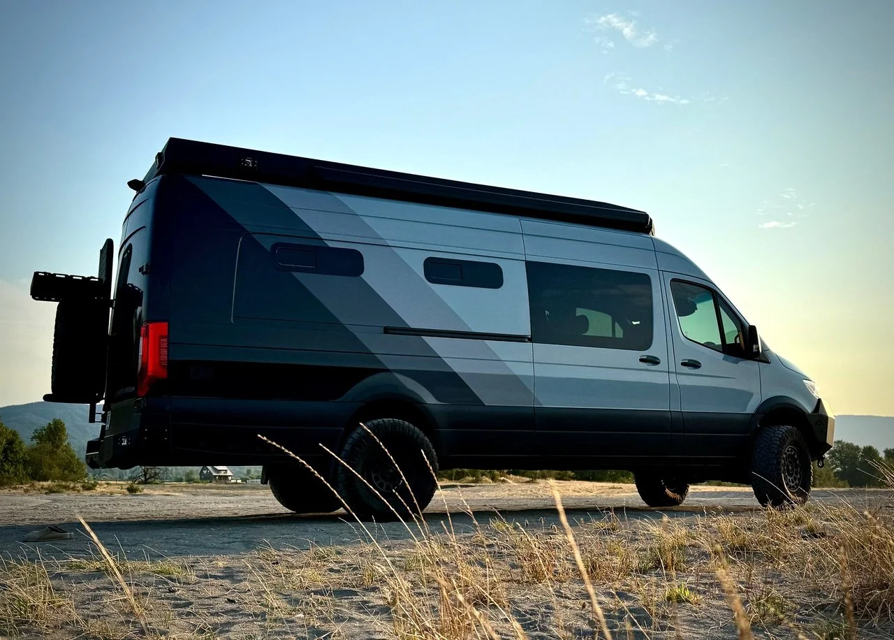 EAV Wolf Adventure Van on a sandy dirt road