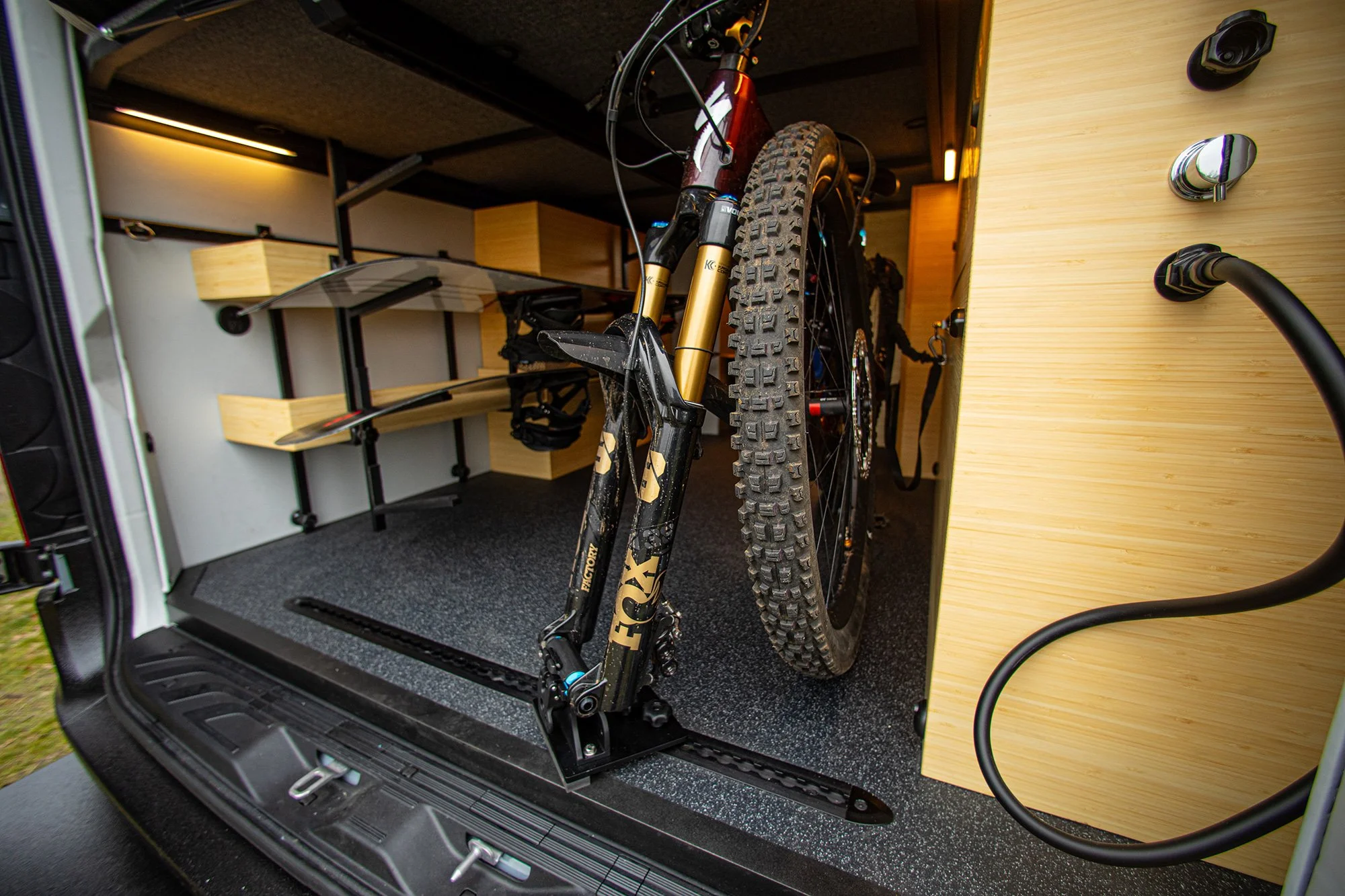 EAV Zephyr Adventure Van's storage options with a mountain bike.