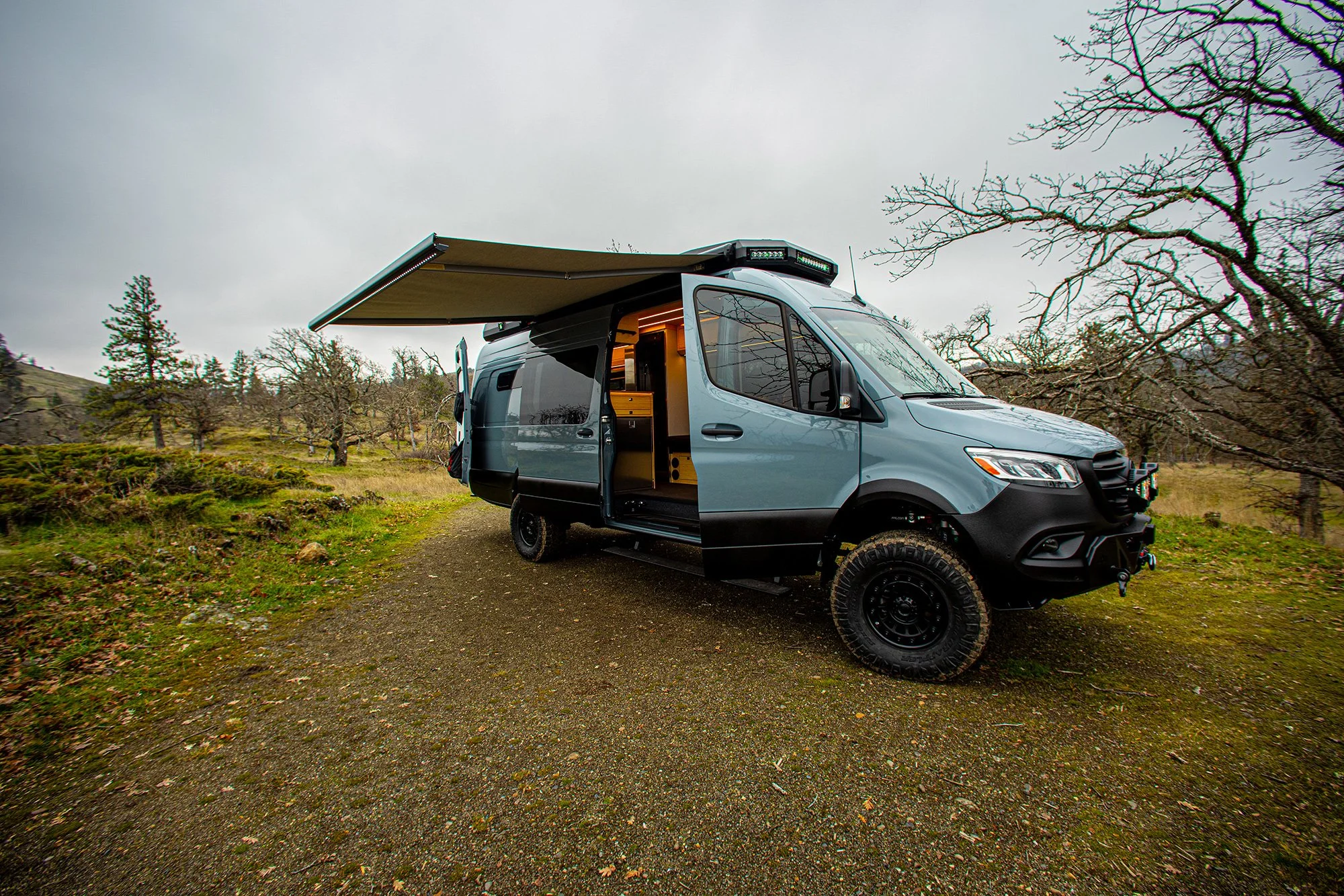 EAV Zephyr Wolf with awning and sliding side door open.