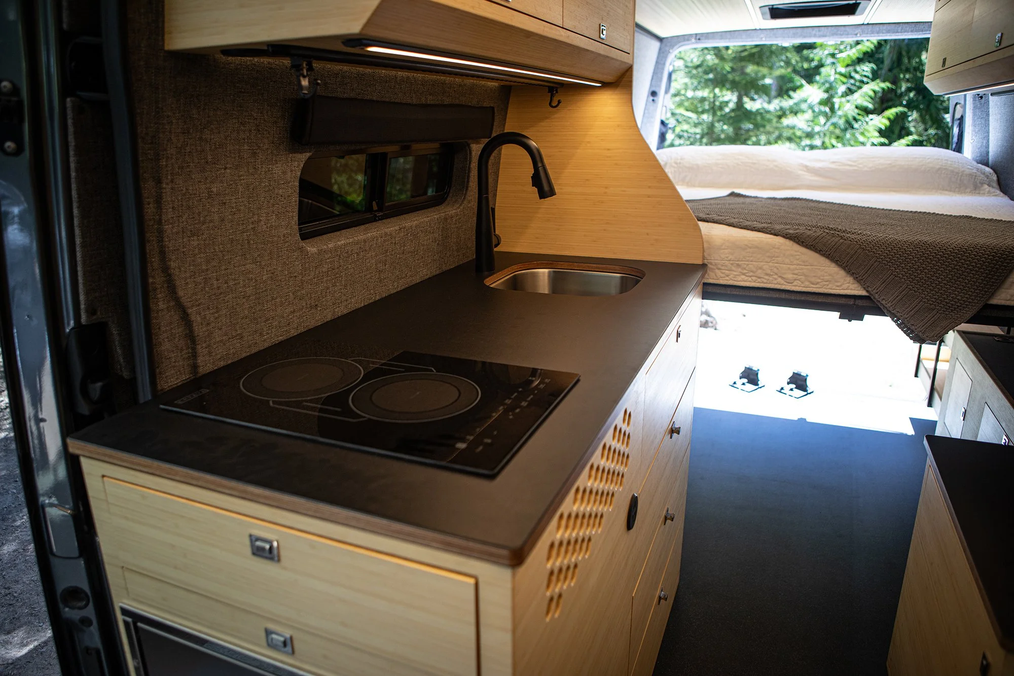 EAV Earl Gray Kitchen with bed setup in background.