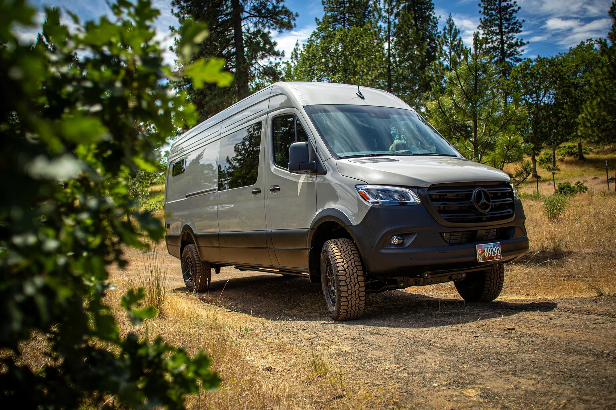 EAV Zahra Adventure Van driving on a gravel road.