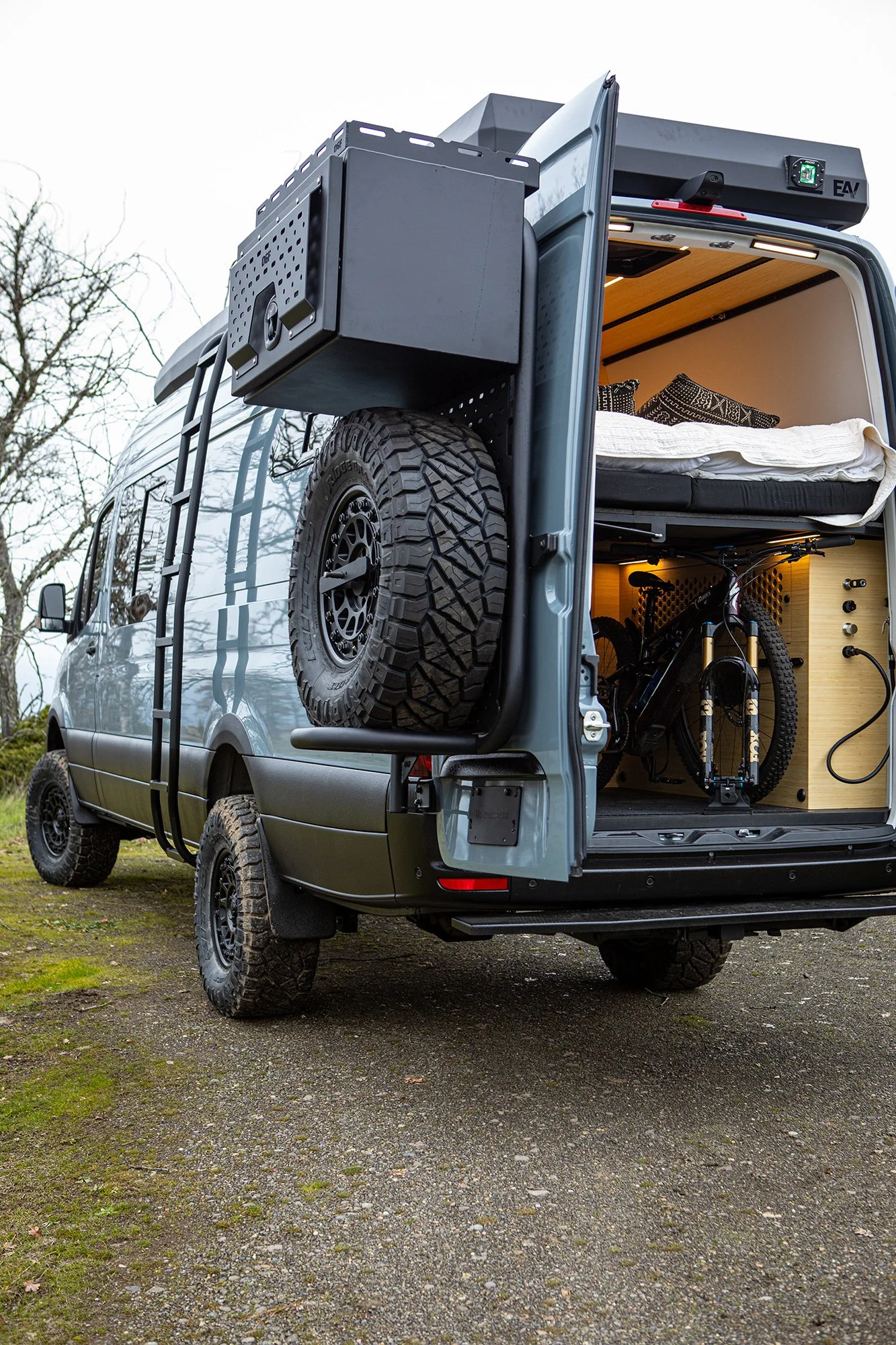 EAV Zephyr Adventure Van's exterior with the back doors open.