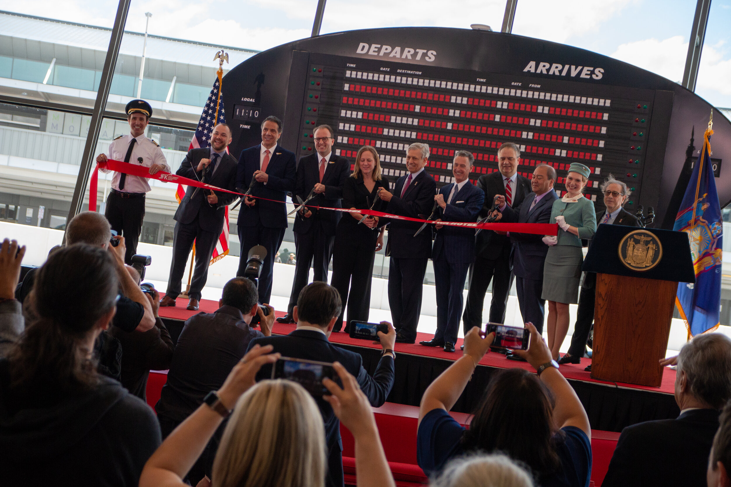 State and local elected officials and stakeholders prepare to cut the ribbon, officially opening the new TWA Hotel | Carolyn Adams