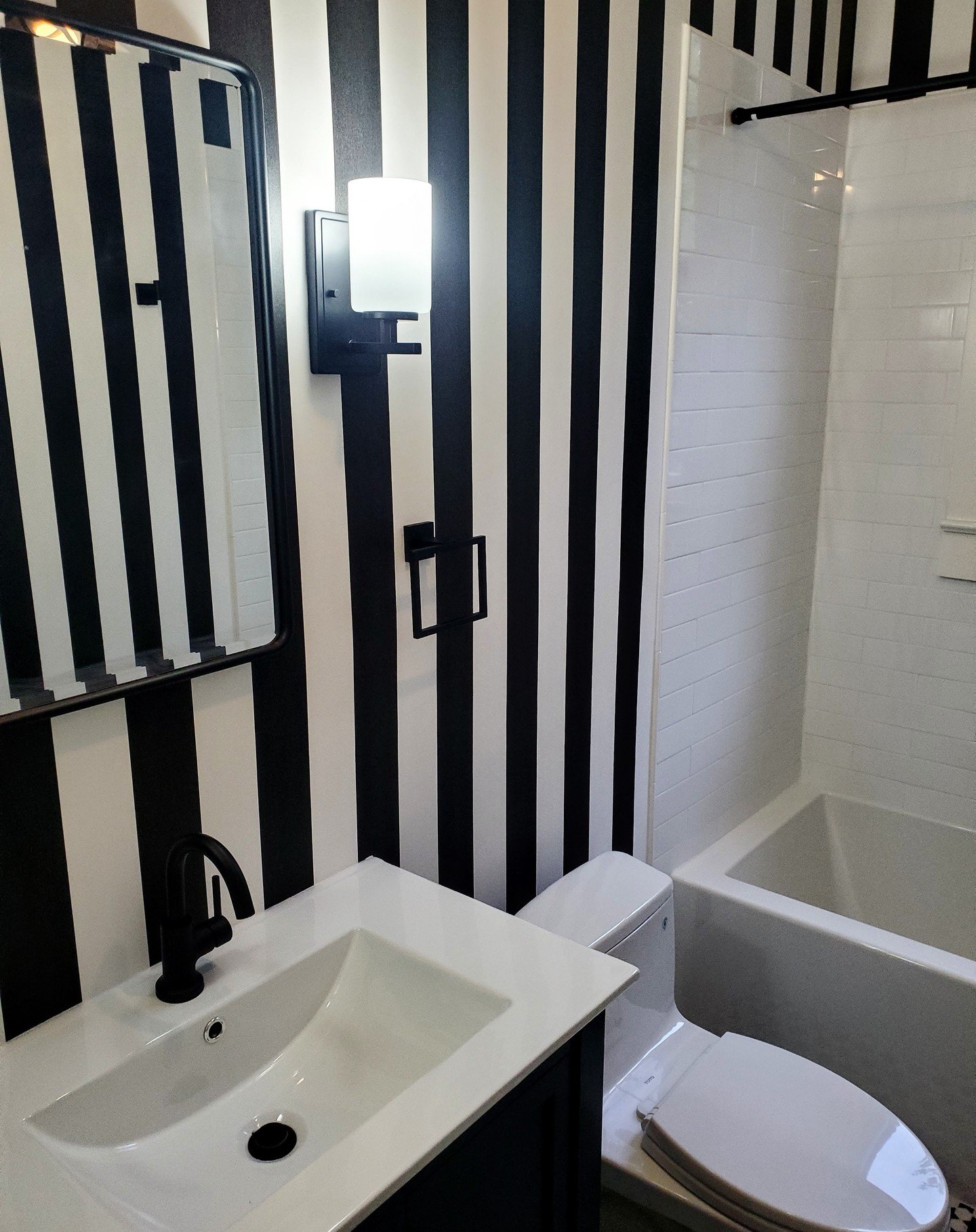 An exciting bath remodel! We love the mix of patterns here, toned down by a limited color scheme. Scroll through to photo 3 of this space when it was in progress, and photo 4 of the bathroom before we began. A huge change! 😮