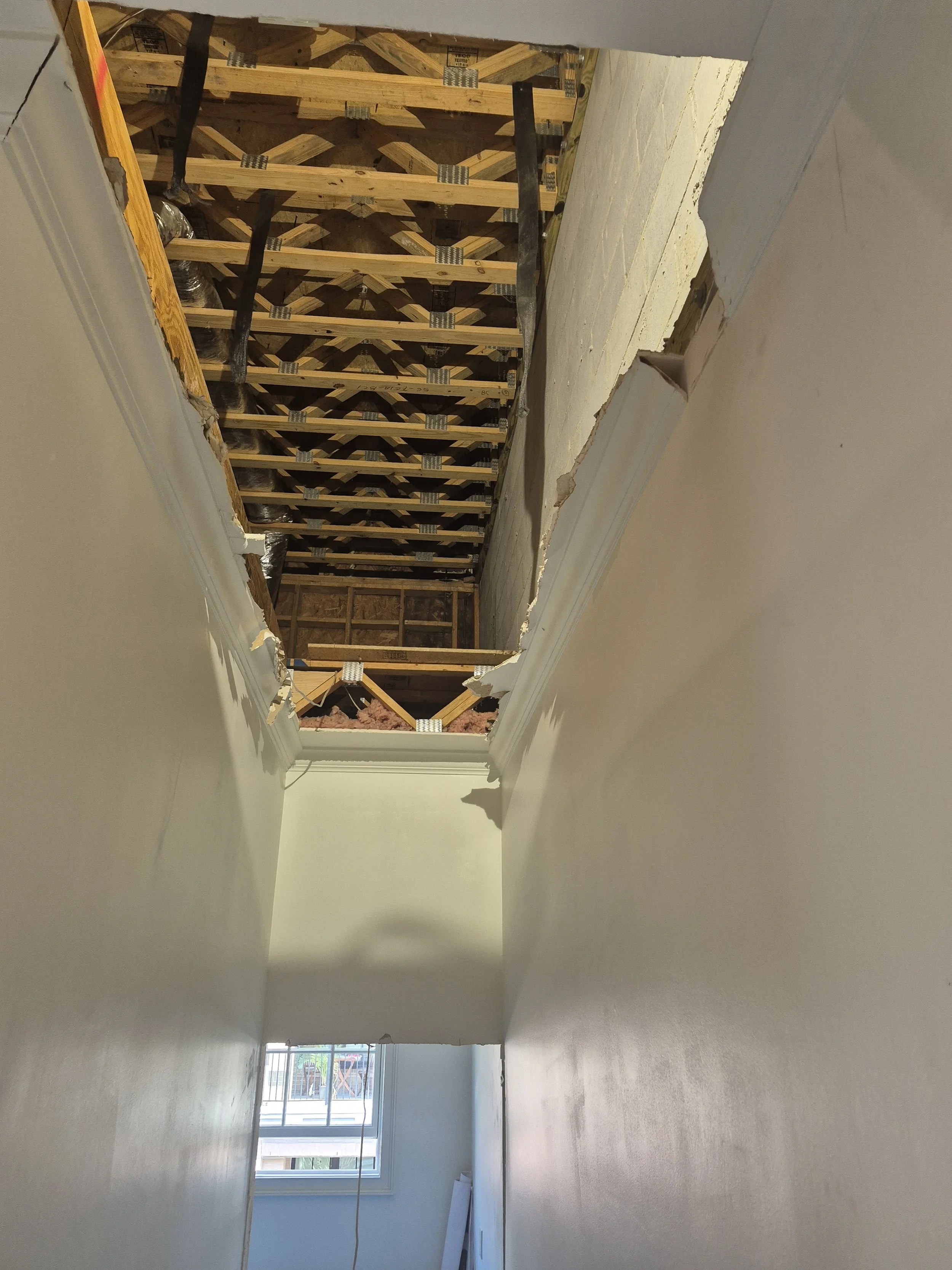 The attic exposed for construction of the  staircase