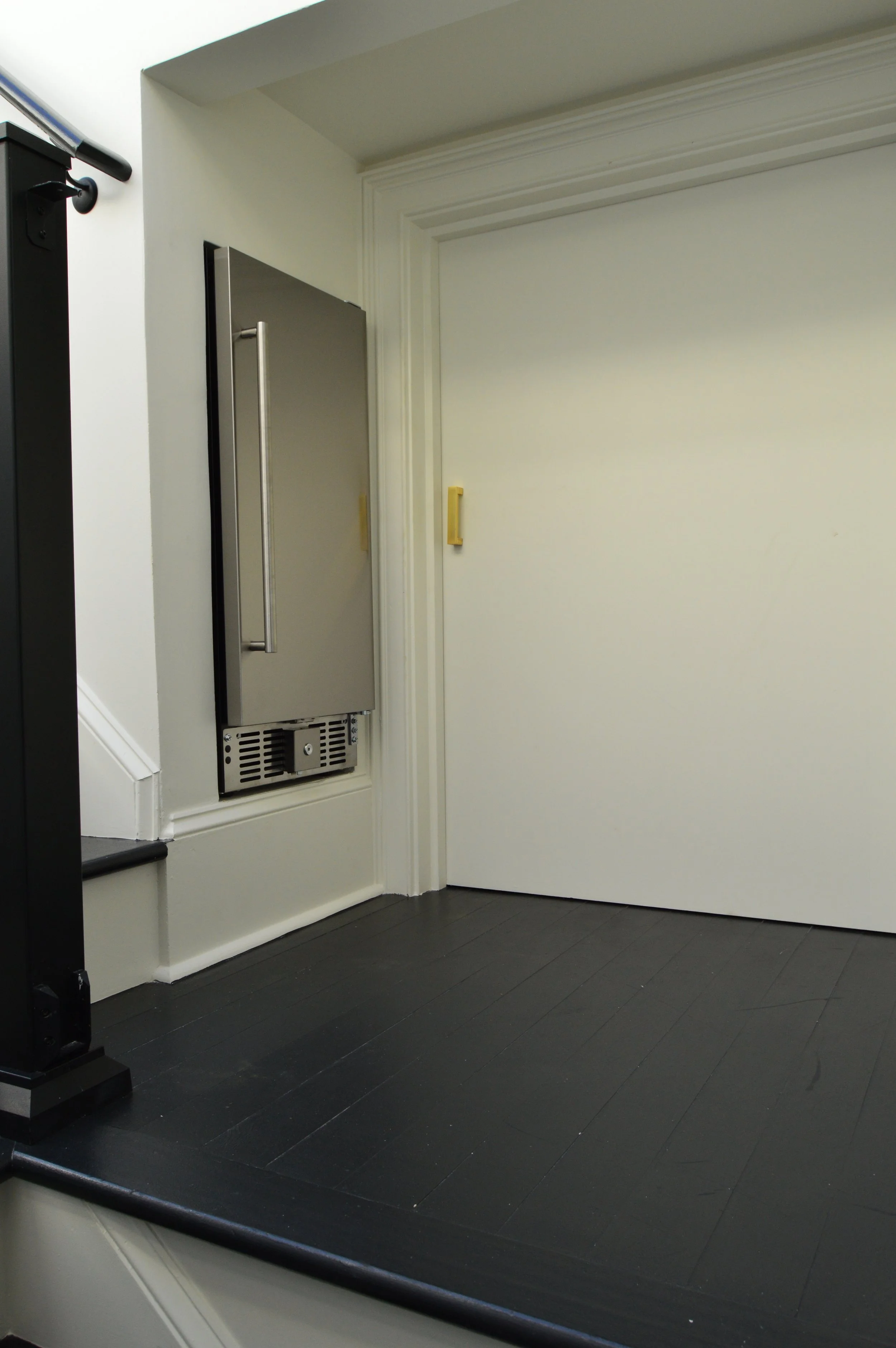 The built in beverage refrigerator on the landing