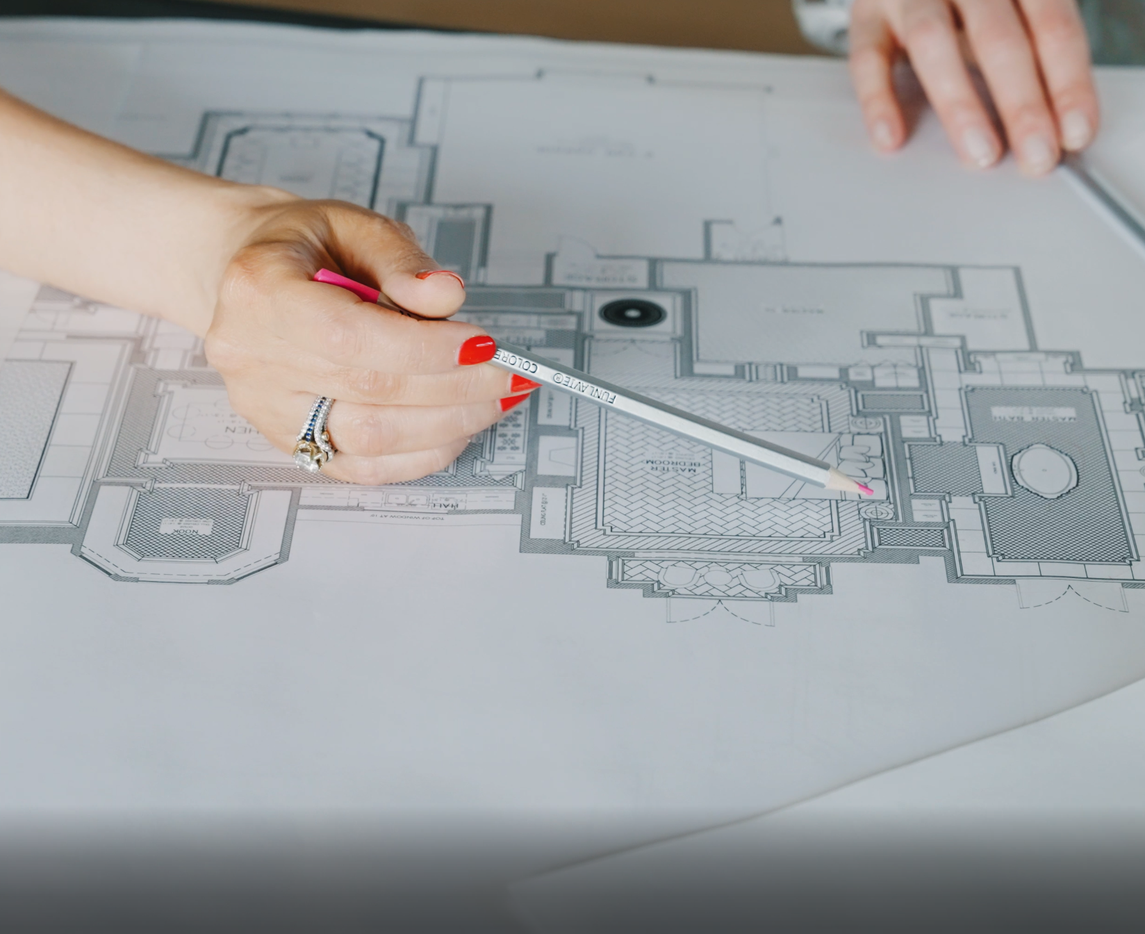 Designer marking up architectural plans during a LUXYSPACE design review