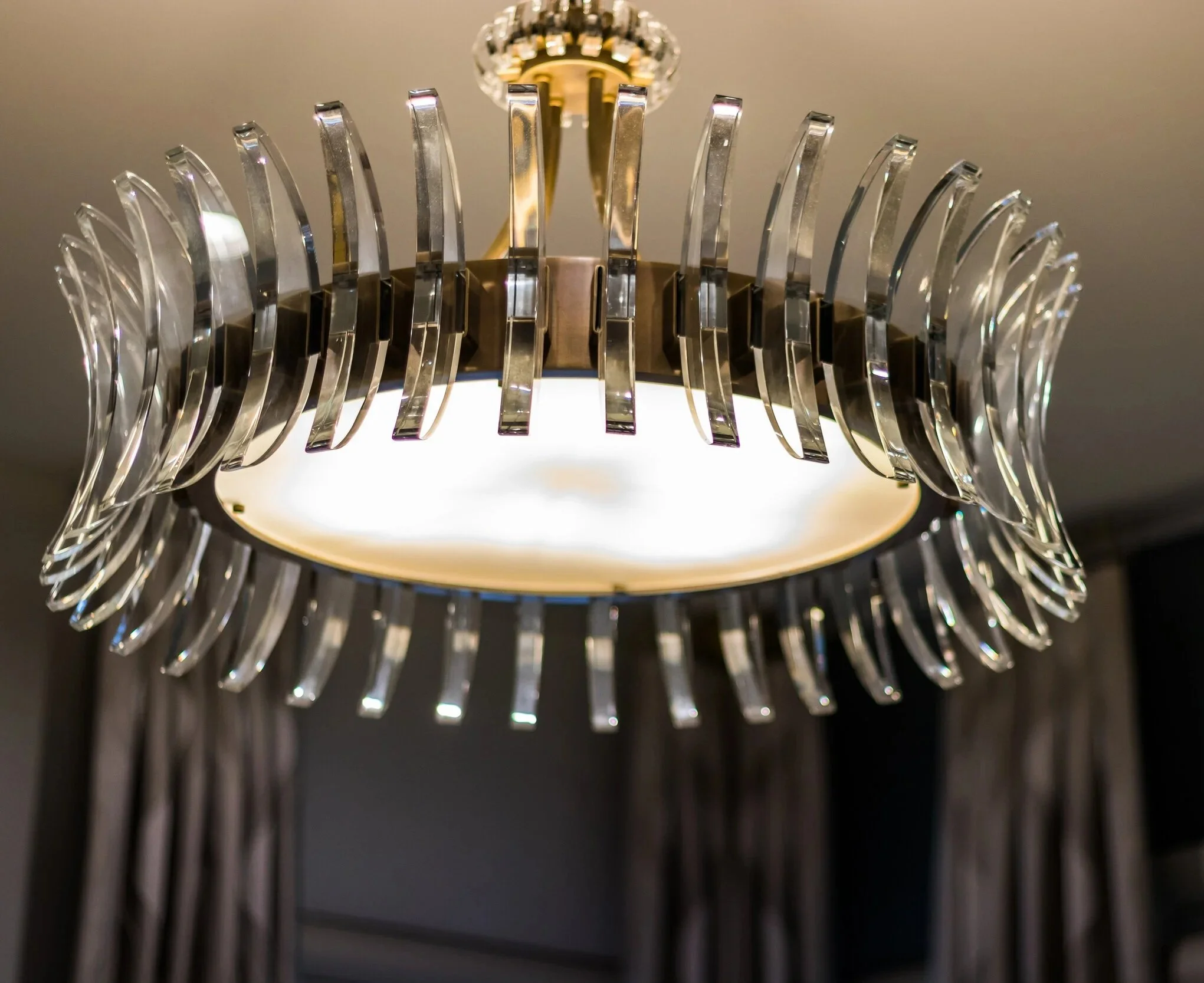 Modern statement chandelier featured in a custom interior design by LuxySpace.