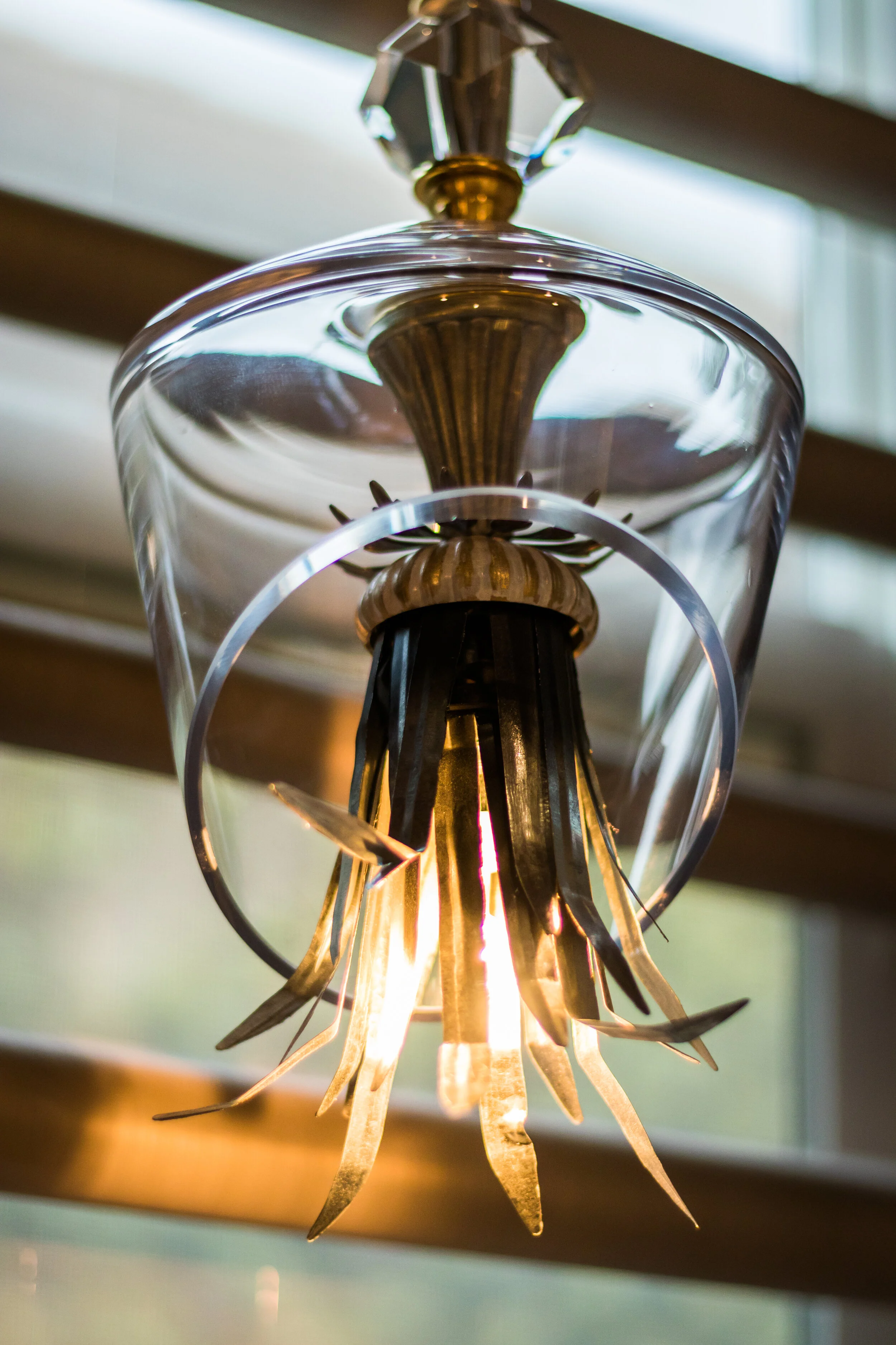 Brass and glass statement chandelier selected by LUXYSPACE custom lighting design
