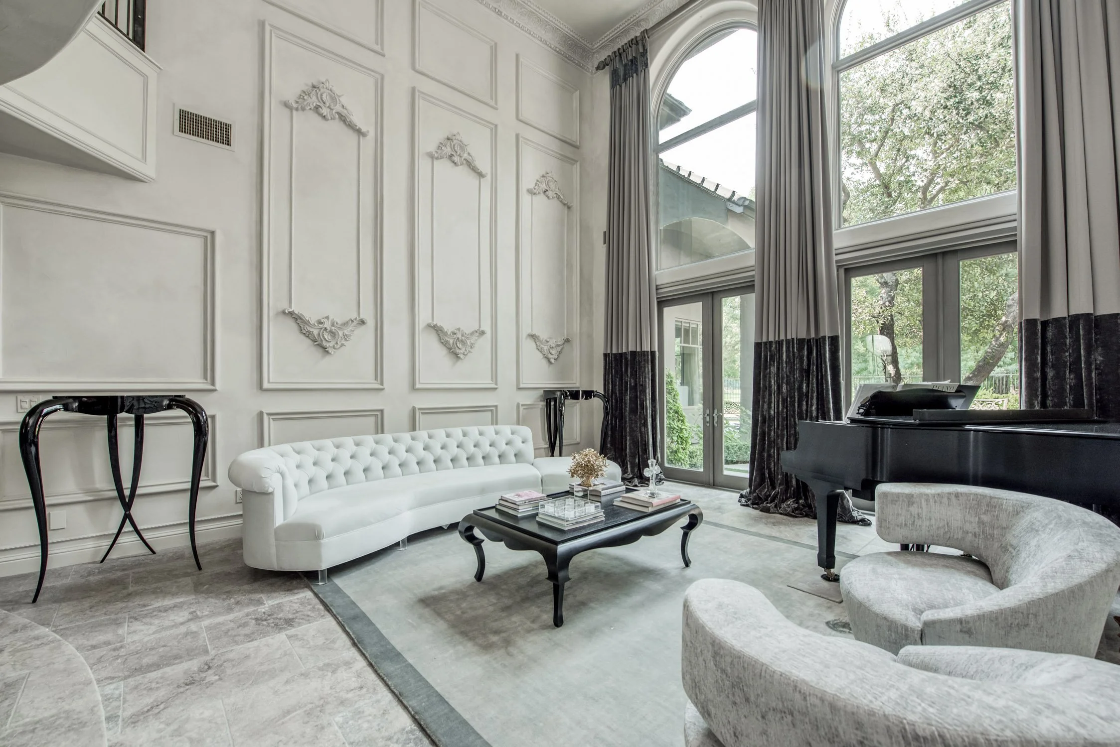 Custom two-tone drapery panels on tall windows in a formal living room by LUXYSPACE