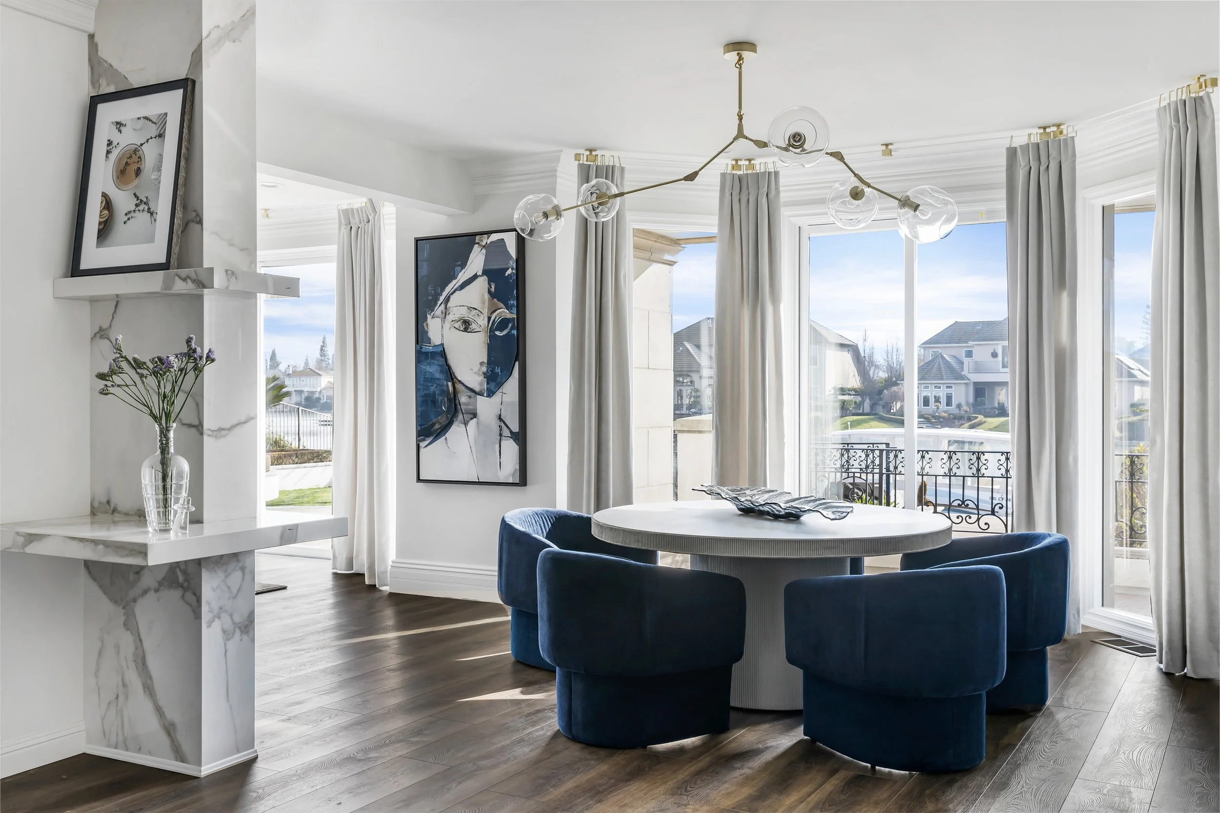 Custom drapery panels around a bay of windows in a lakefront dining nook, Lakeside View by LUXYSPACE