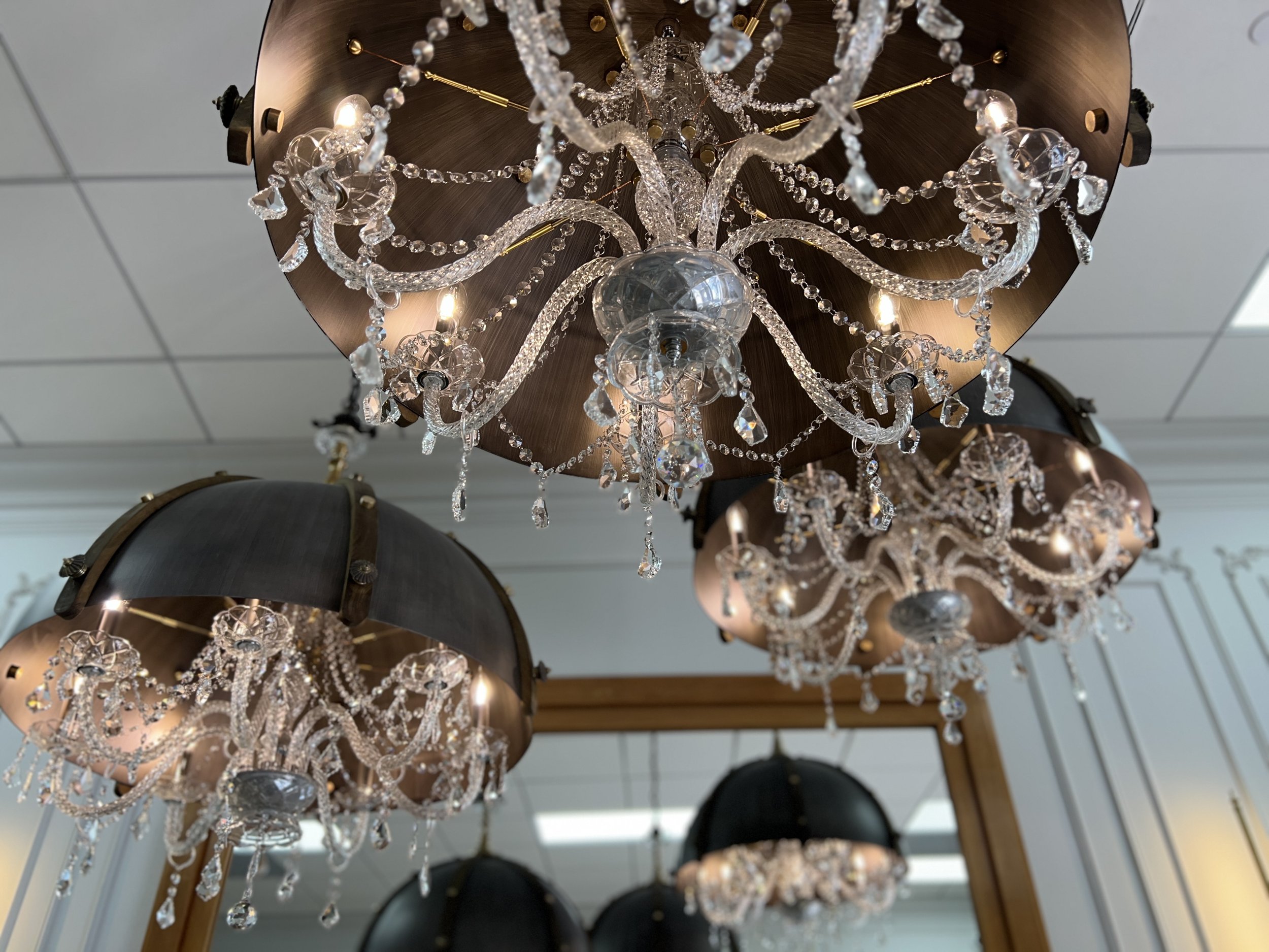 Clustered jellyfish dome chandeliers with crystal details at Kaz Jewelry showroom