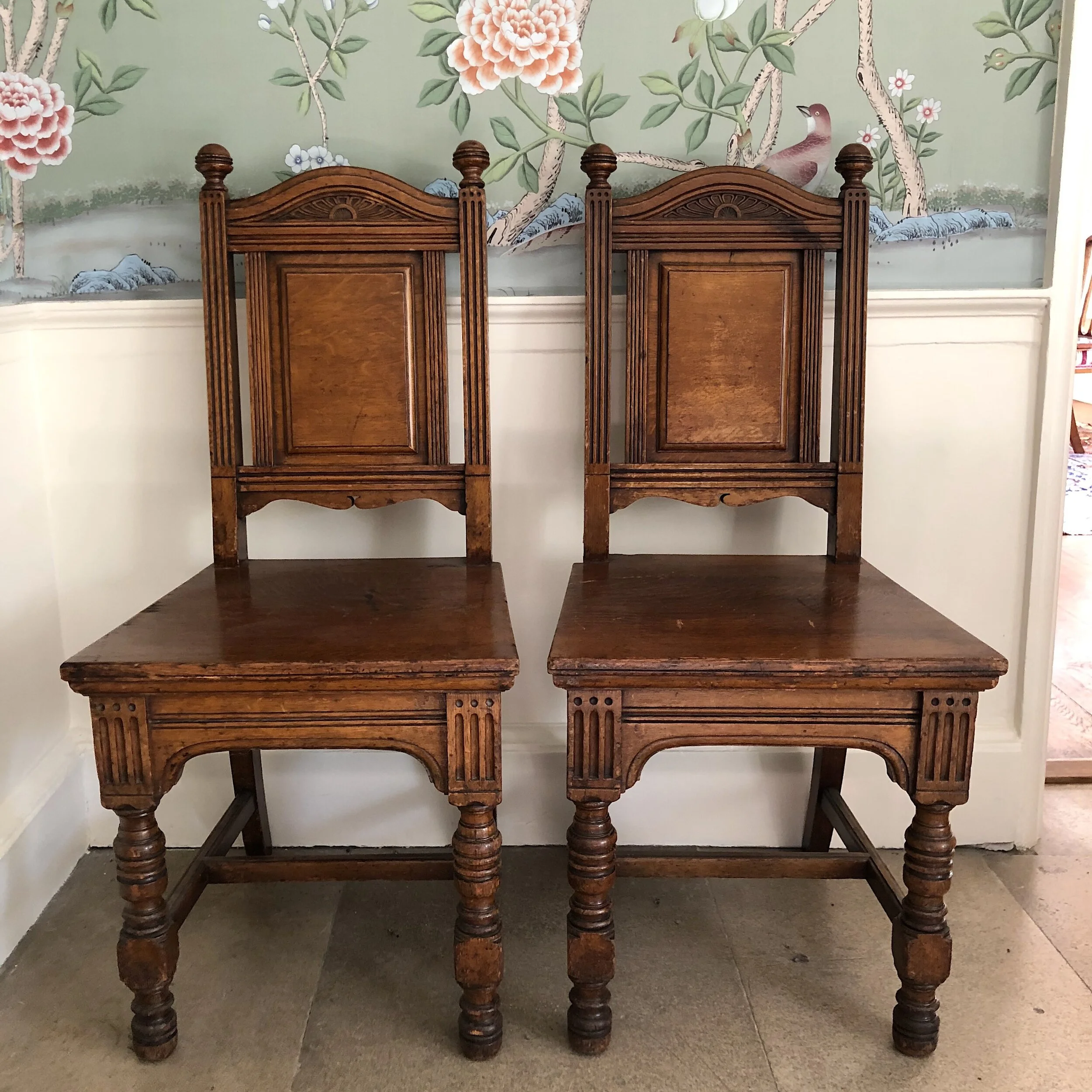 4. A pair of antique oak hall chairs