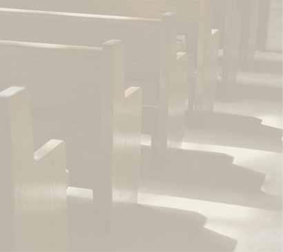 Empty church pews with sunlight casting shadows on the floor.