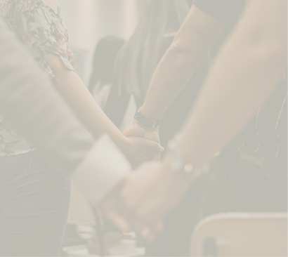 Group of people holding hands during a handshake or moment of connection.