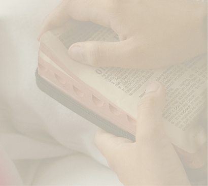 Person holding a Bible with both hands.