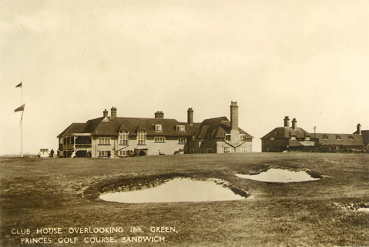 A vintage photograph of a large club house overlooking a golf course with multiple sand traps, located at the Princes Golf Course in Sandwich.