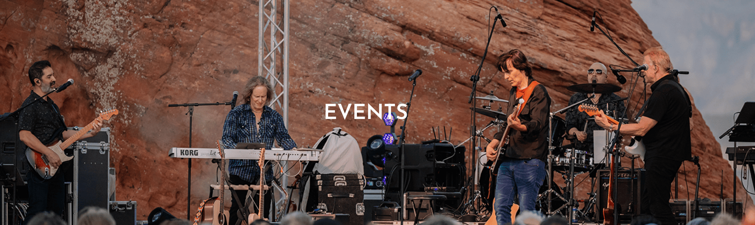 A live outdoor band performing against a rocky backdrop with the word 'EVENTS' overlaid.