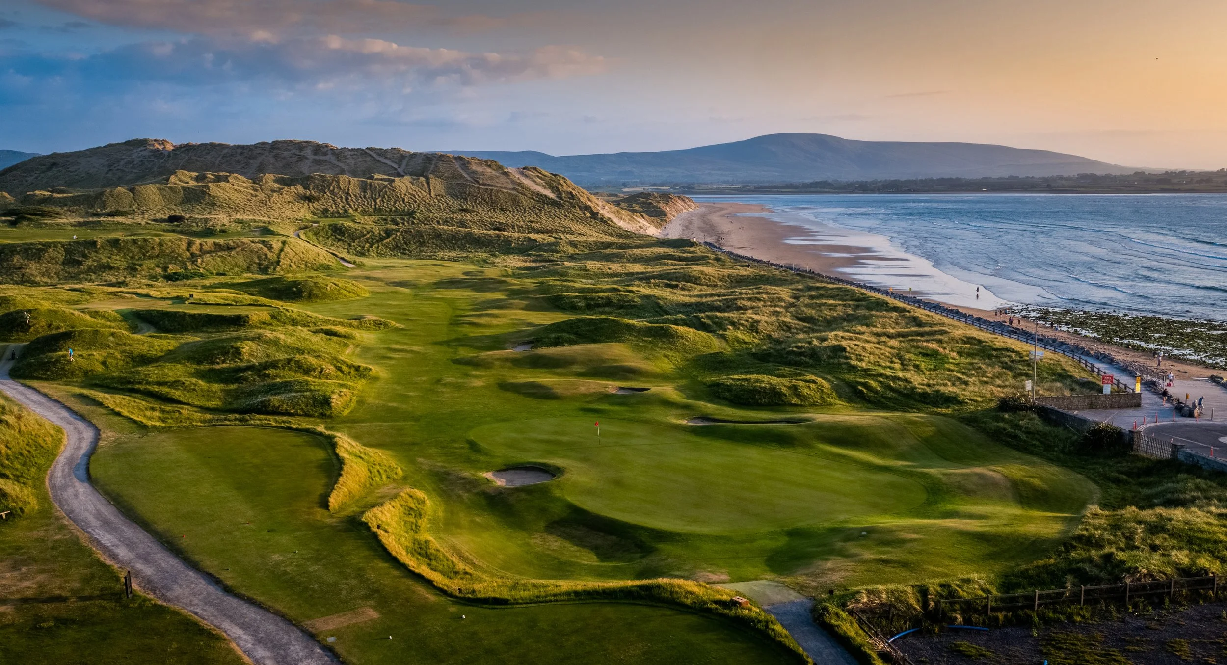 Beautiful links-style golf course at Strandhill Golf Club set against a dramatic coastline, showcasing the stunning oceanfront courses available on custom golf trips to Ireland.