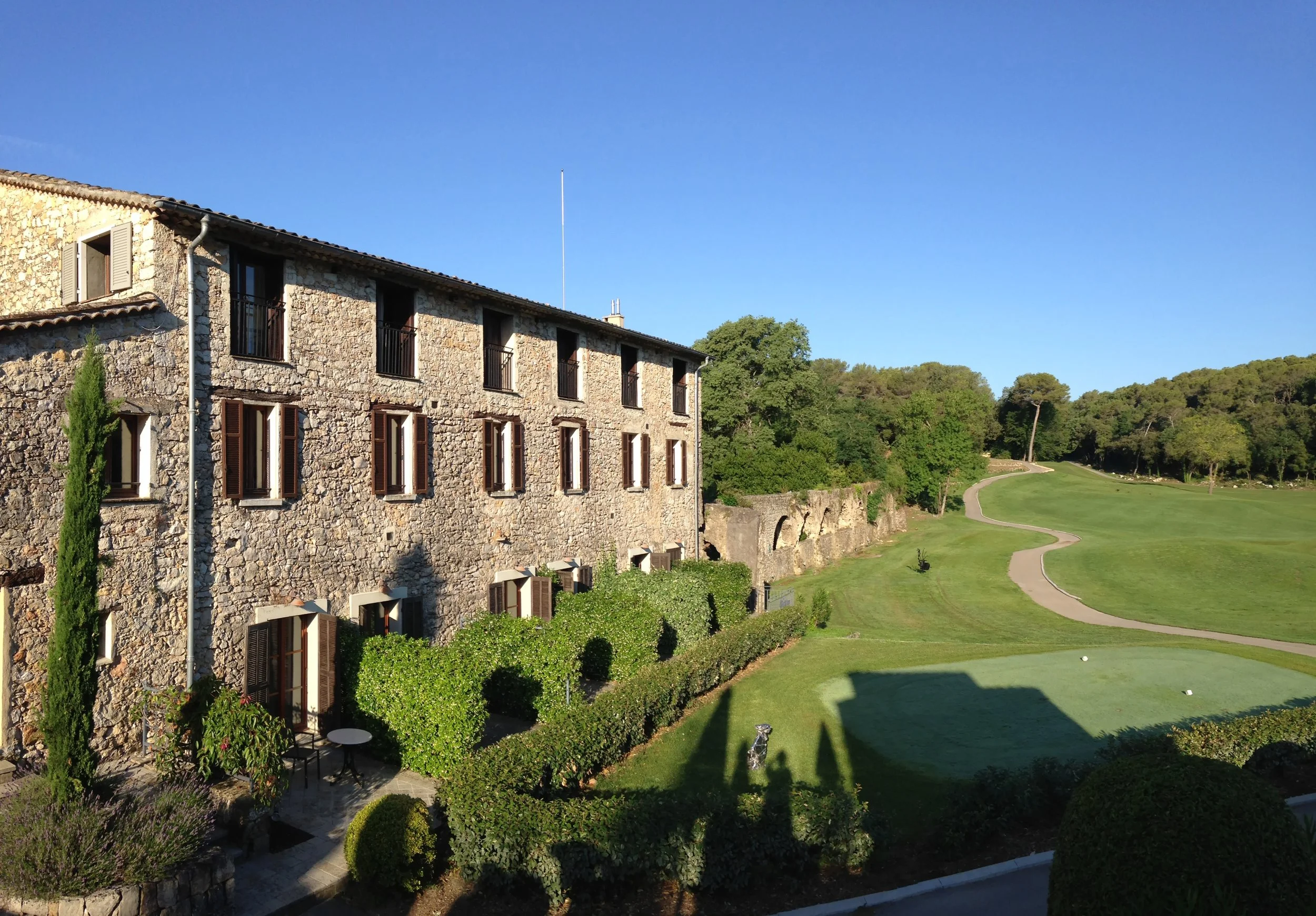 "The Hotel Chateau de la Begude overlooking a manicured golf course in France."