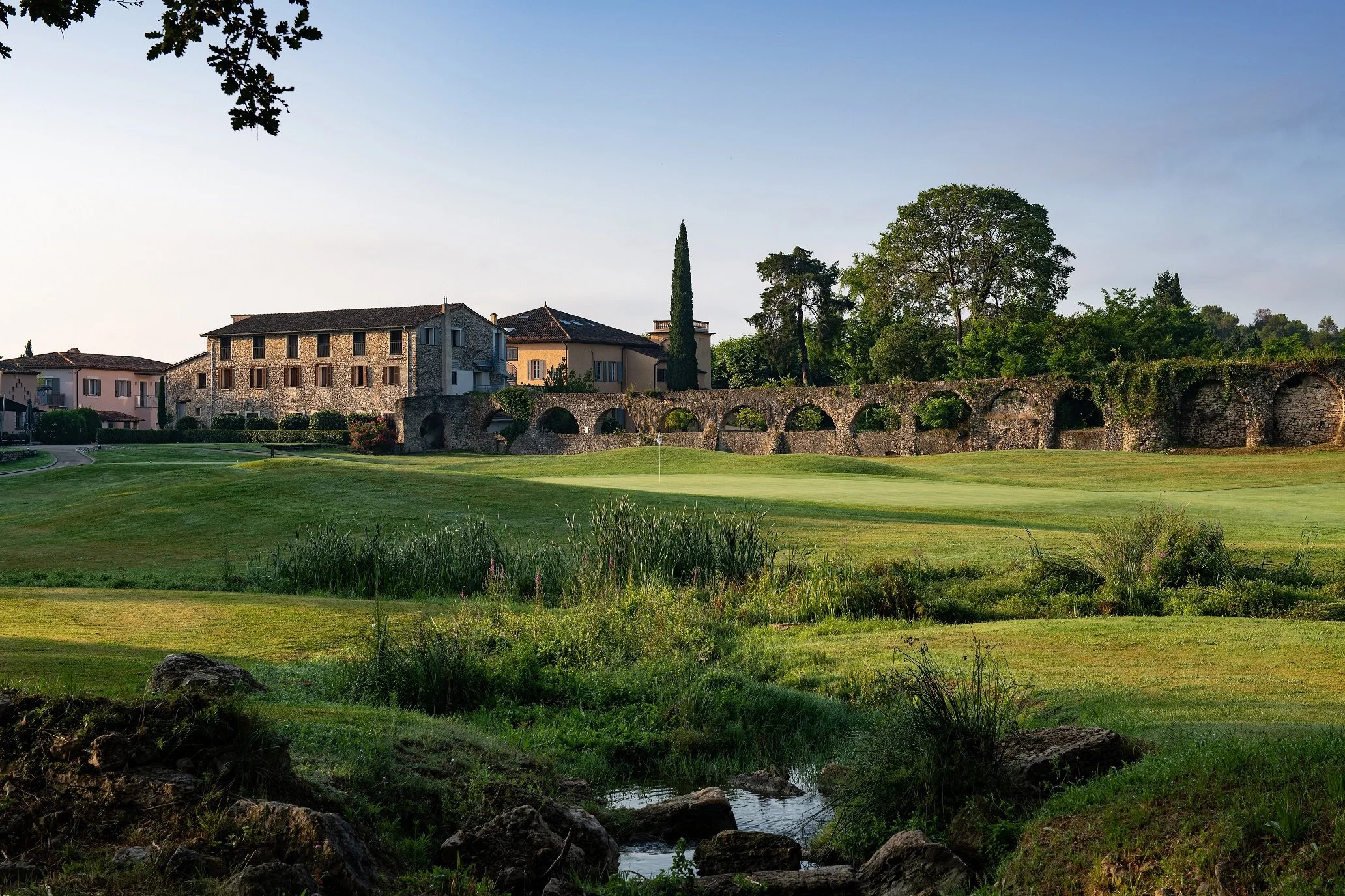"Hotel Chateau de la Begude overlooking a beautiful golf course surrounded by old stone ruins."