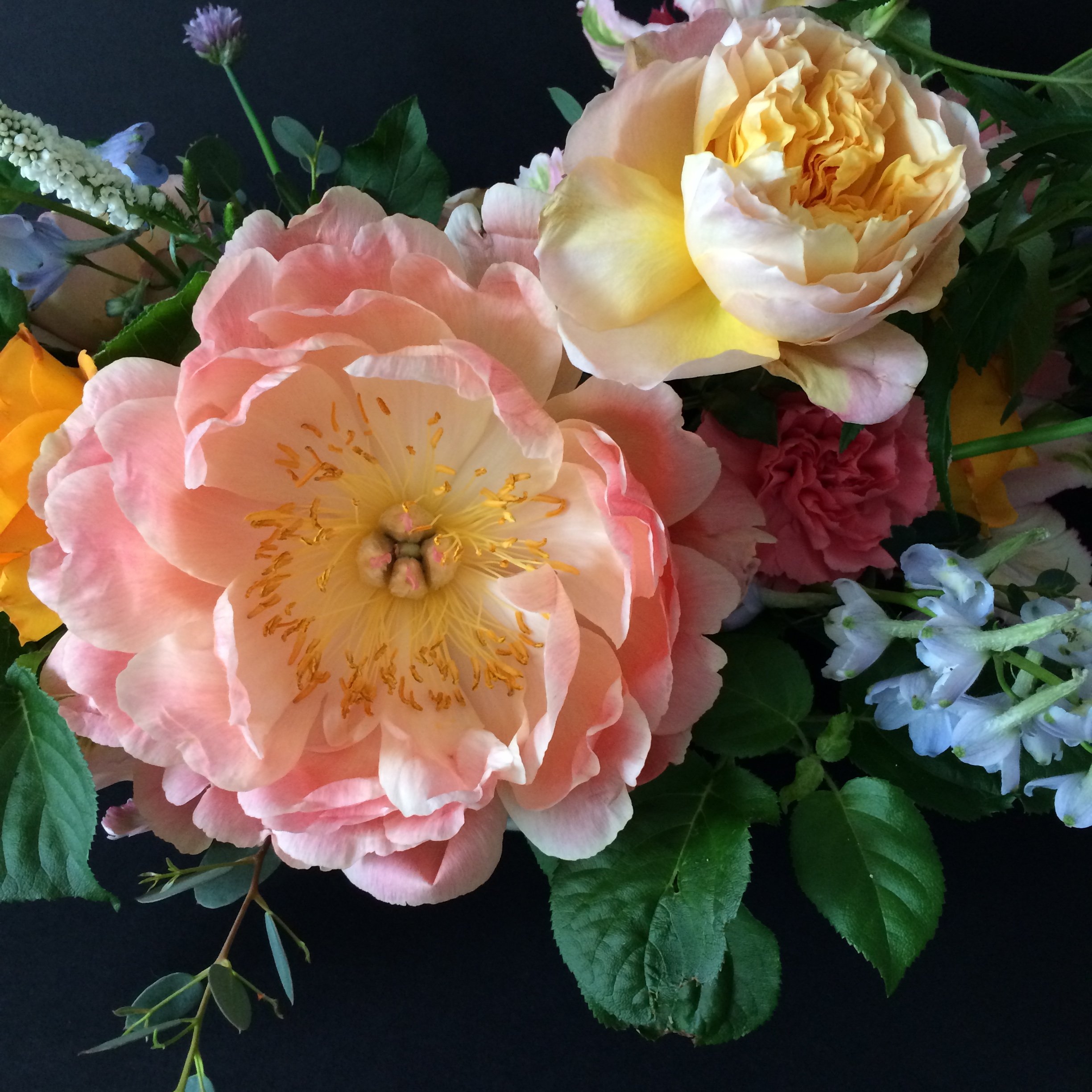 a close up of bouquet with pink peonies and other spring flowers