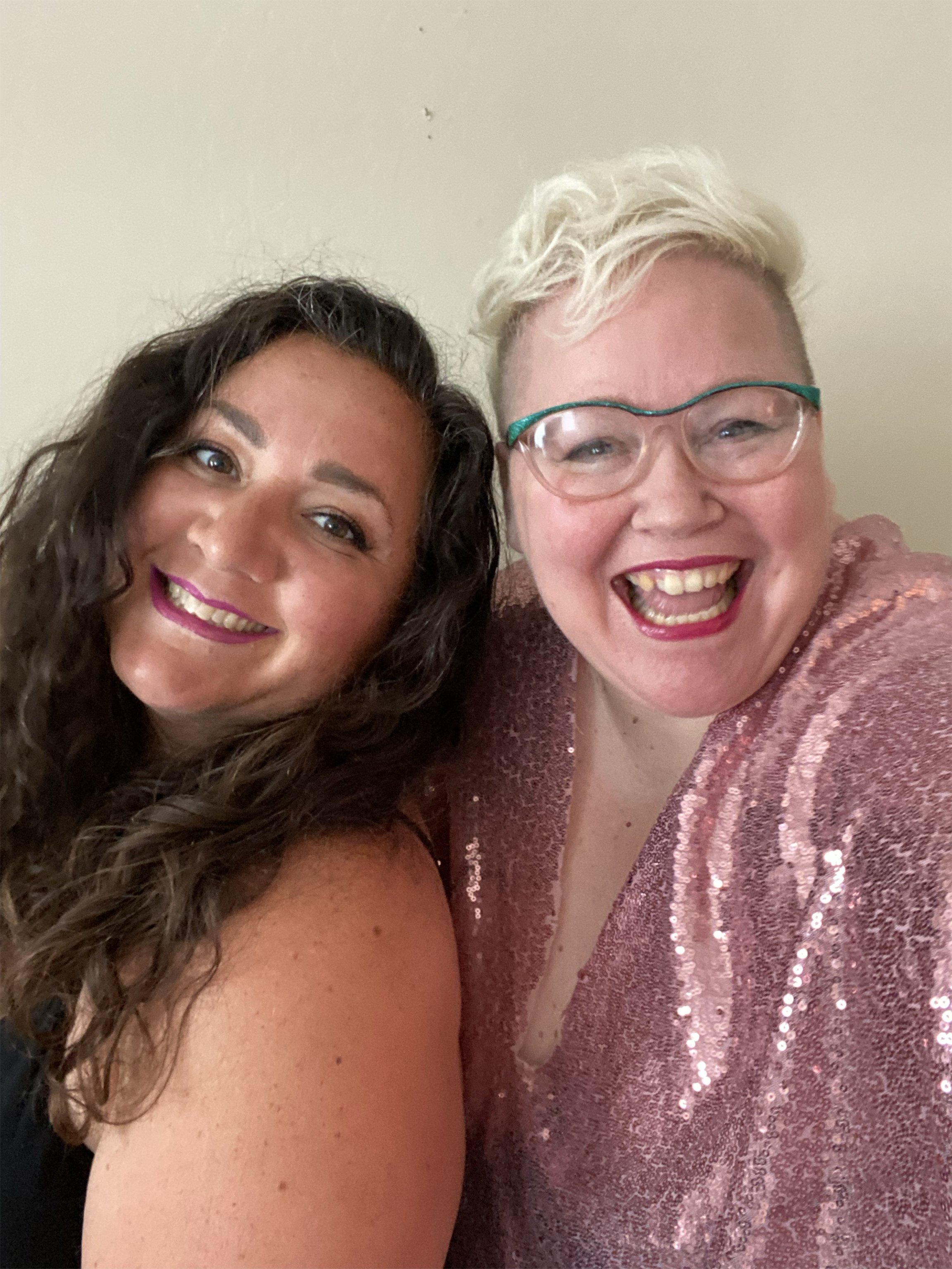 two smiling female podcast hosts