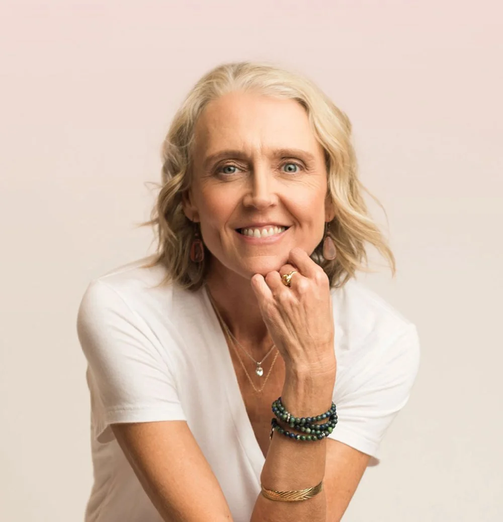 Transformational life coach Rebecca Saxon sitting with her arms crossed