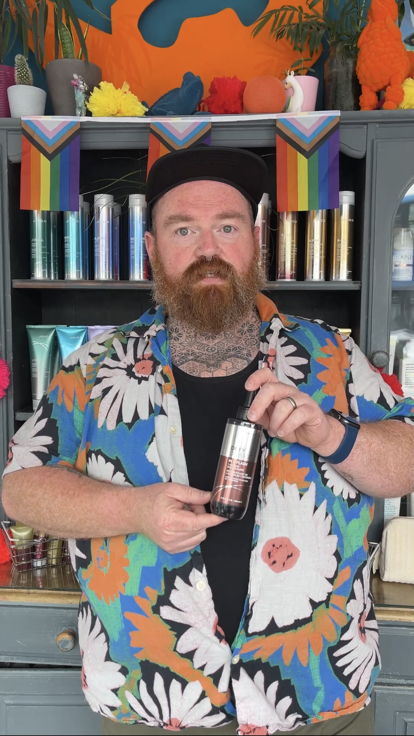 James from JamesB Hair holding a professional hair treatment product inside the Bristol salon.