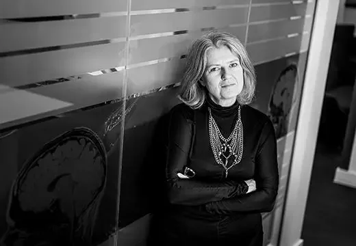 Sally Marlow standing in front of a glass partition