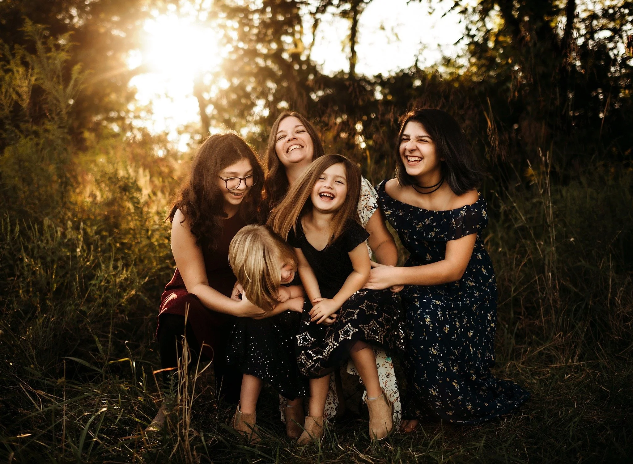 mom and kids playing at sunset