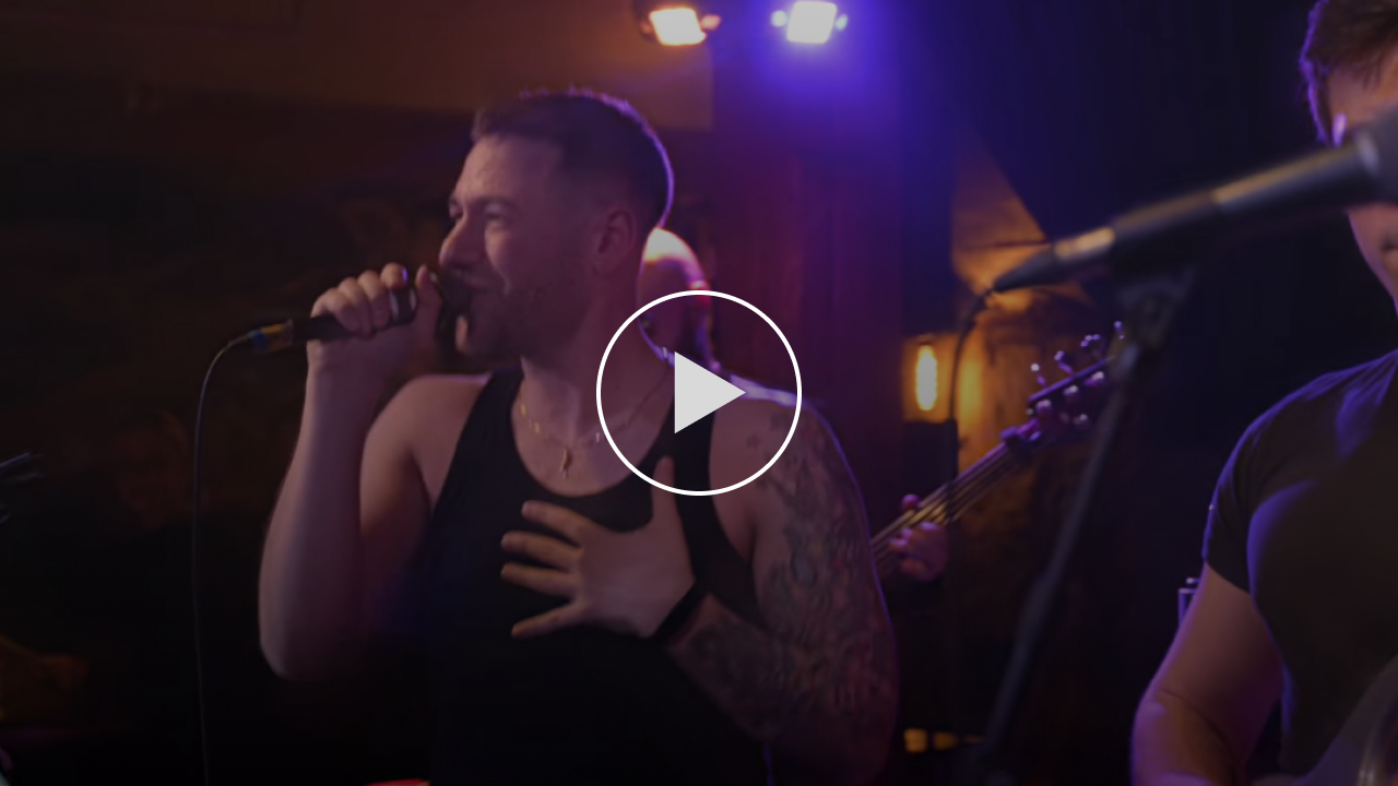 Stephen Scaccia performing a soulful live cover of "I Say A Little Prayer" on stage under warm theatrical lighting.