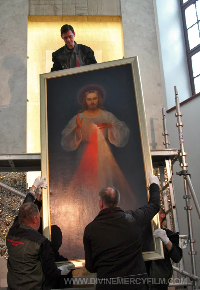 Workers carefully removed the priceless painting from the niche and gently brought it down to the floor.