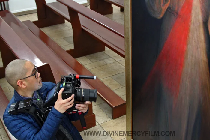 Cameraman Marc Jarabe takes a moment from his work to venerate the painting and admire the unimpeded beauty.