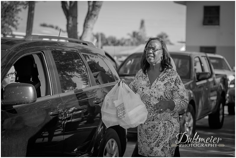  Thelma Washington, executive director of the Gertrude Walden Child Care Center, delivers meals to the people in a car. 