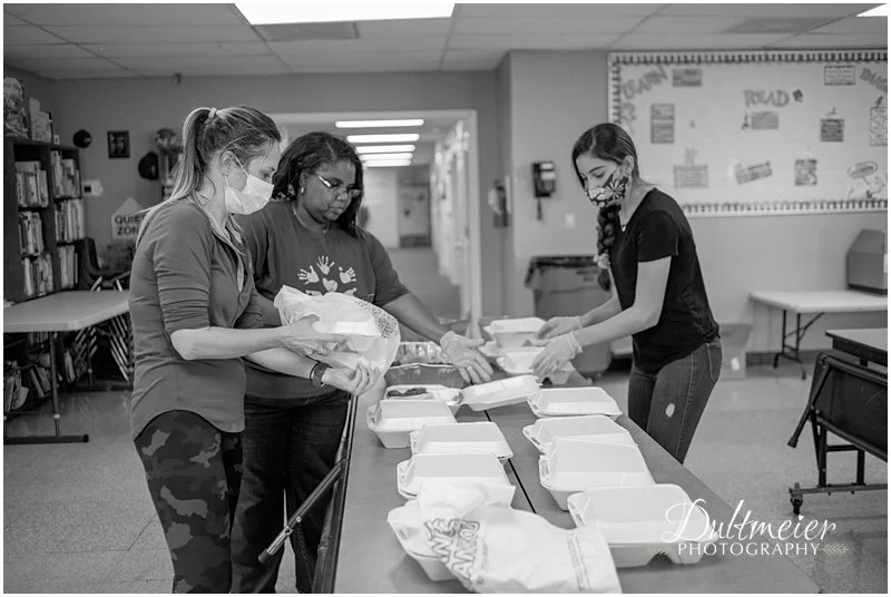  Becky Richmond, Tameka Williams and Sofia Macias package food. 