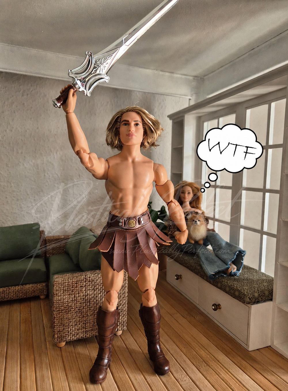 The He-Man Ken, posed in the “I have the power!” iconic pose…in the middle of Moira’s living room.  Moira is behind him, sitting in the reading window, with Loki.  A thought ubble floats above her head, in it, the following letters: WTF.