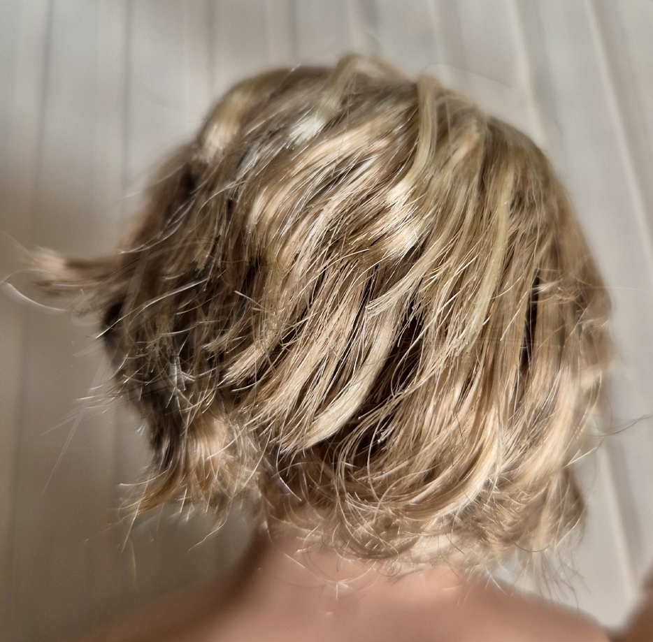 The oddities of the haircut, up close.  It looks weirdly chopped and messy, but not in a nice way.