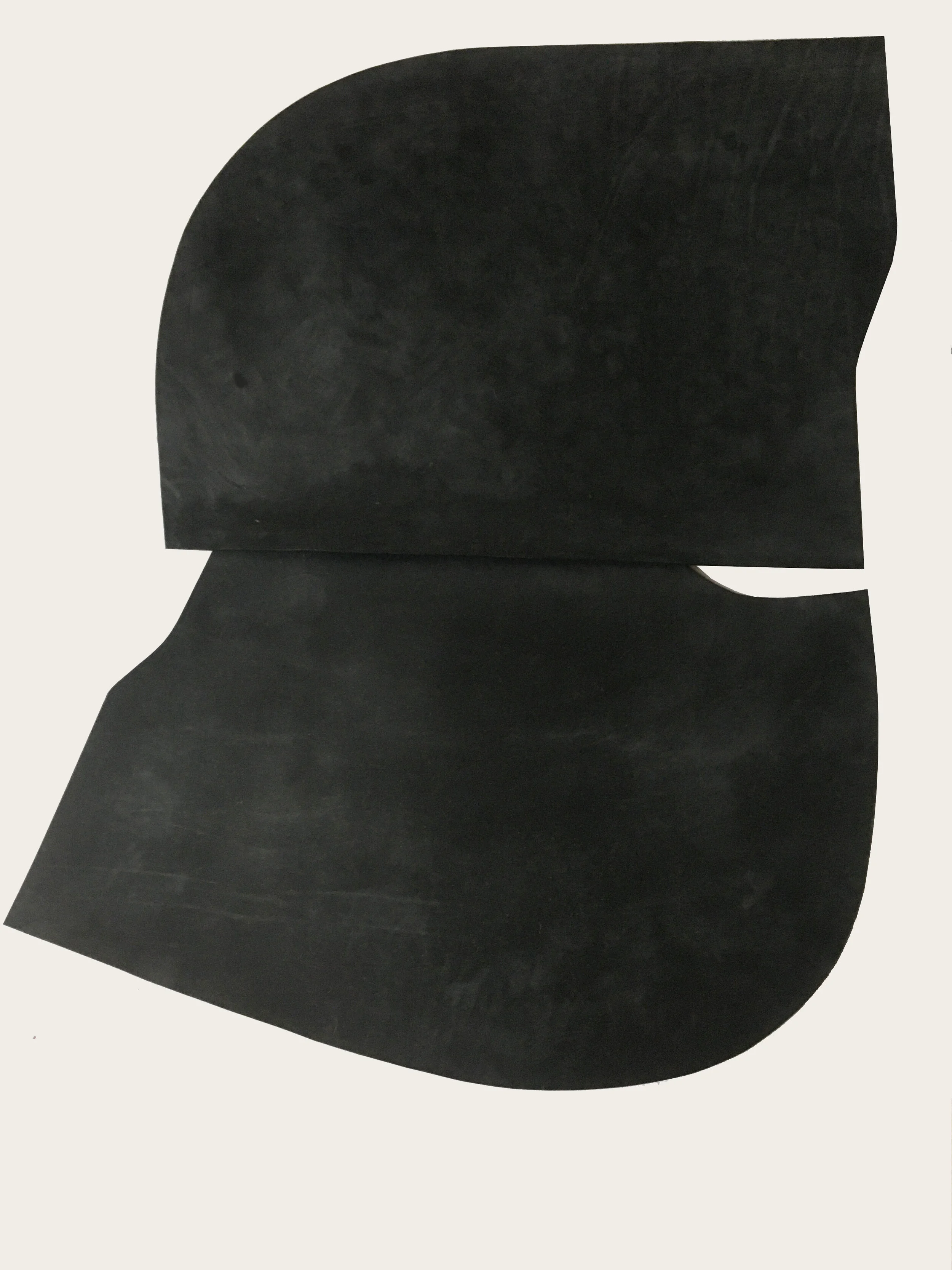 ‘Overlap’, 2020. Black, Oak bark tanned leather, 95 cm L x 130 cm W x 1 cm D