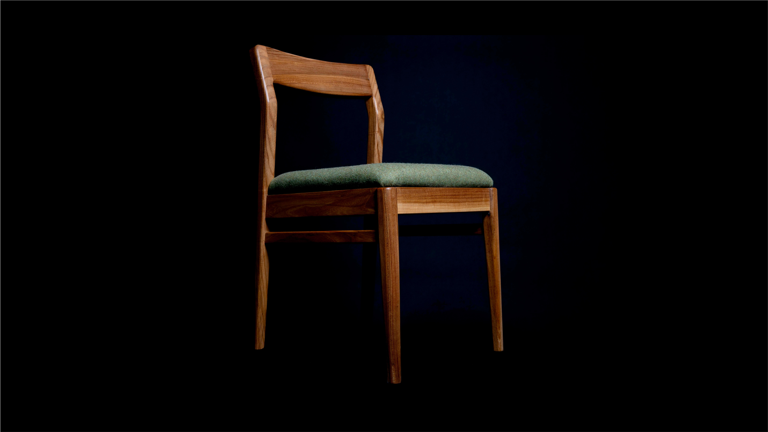 lternative front angled view of Clava Dining Chair in elm.