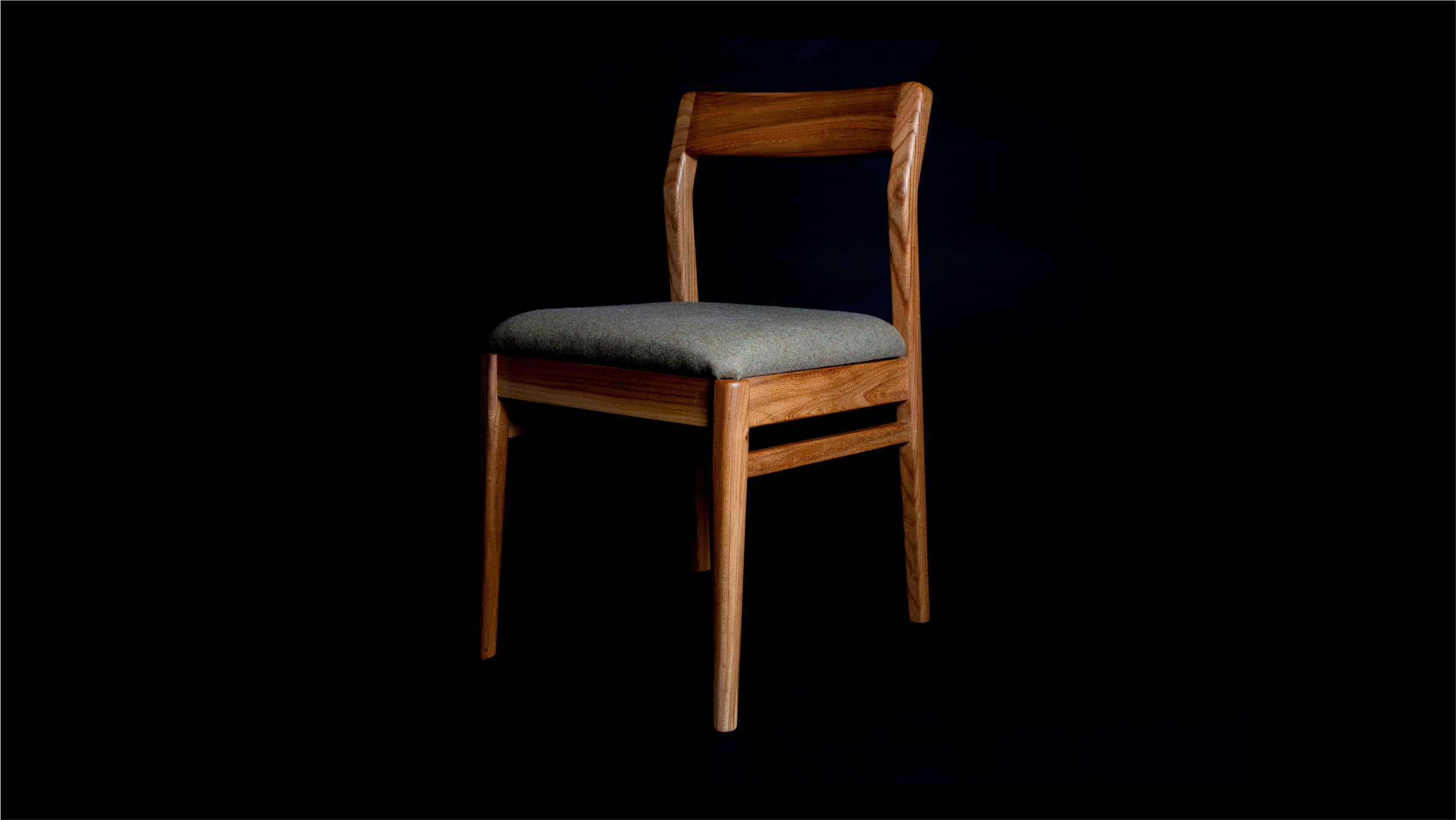 Front angled view of Clava Dining Chair in elm.