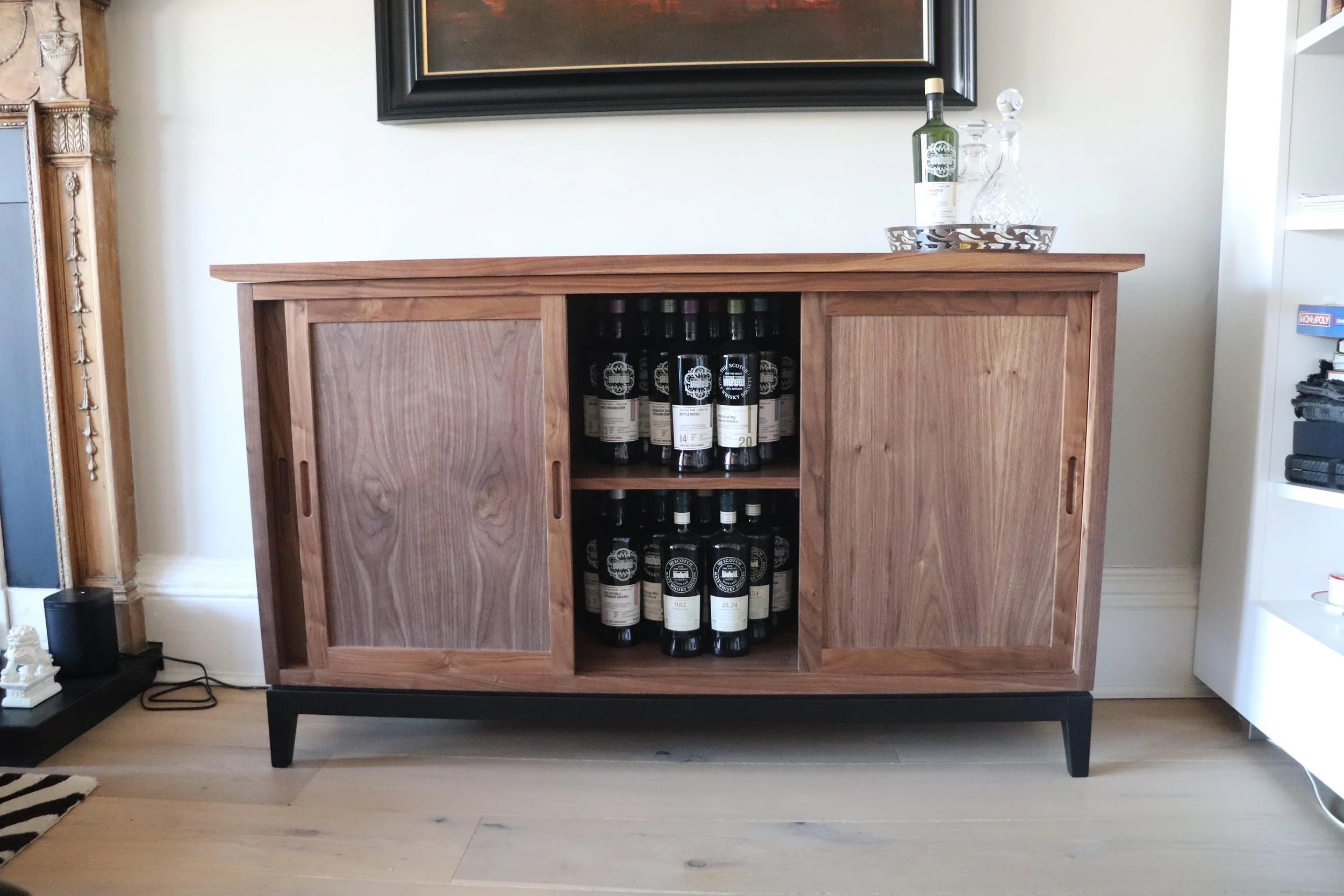 Front view of the Galloway Whisky Cabinet with whisky bottles.