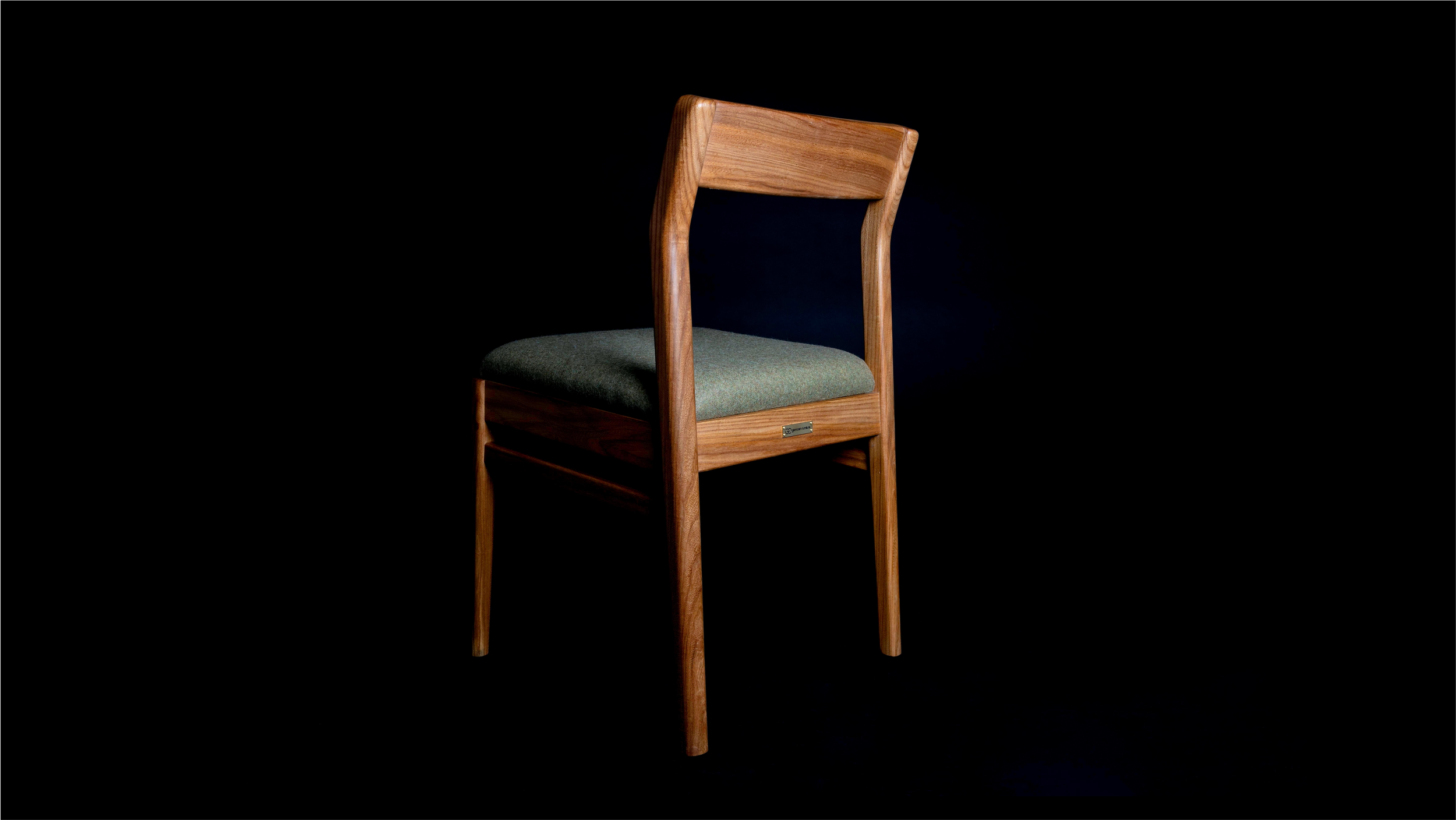 Alternative back angled view of Clava Dining Chair in elm.
