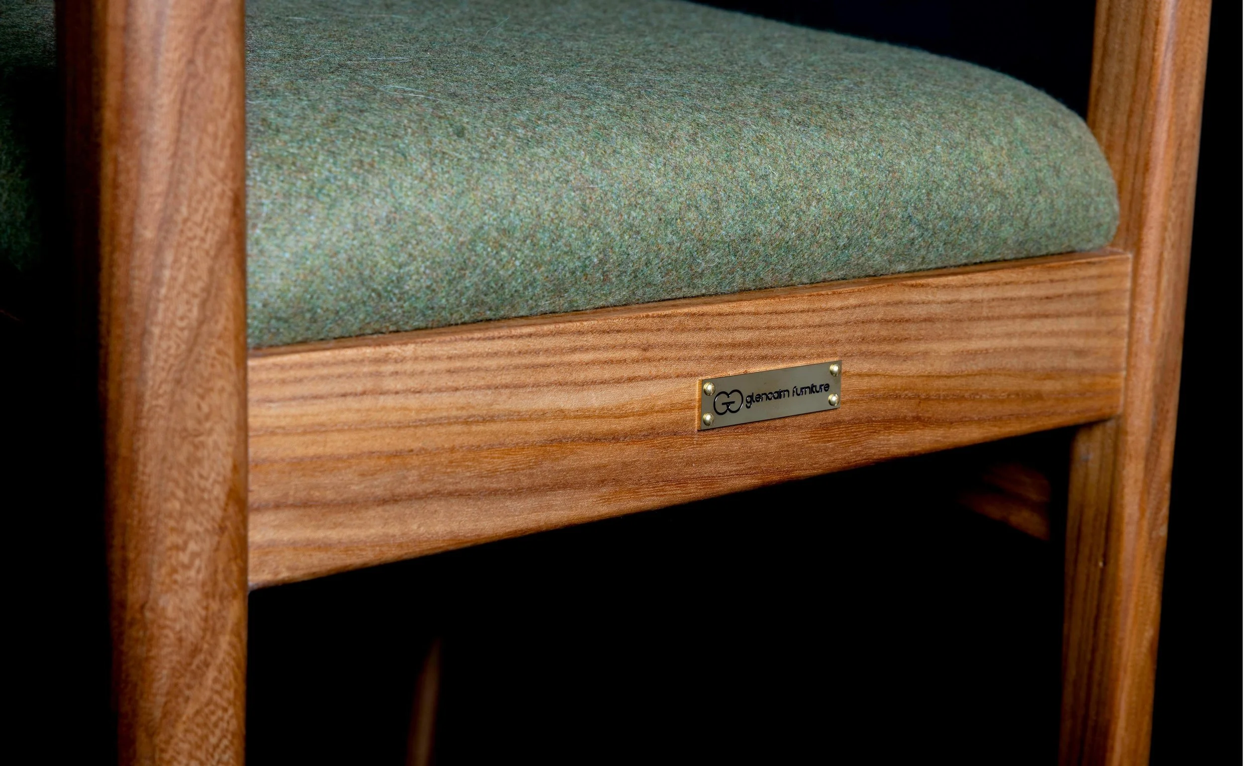 Close up of Glencairn Furniture badge on back rail of Clava dining chair.
